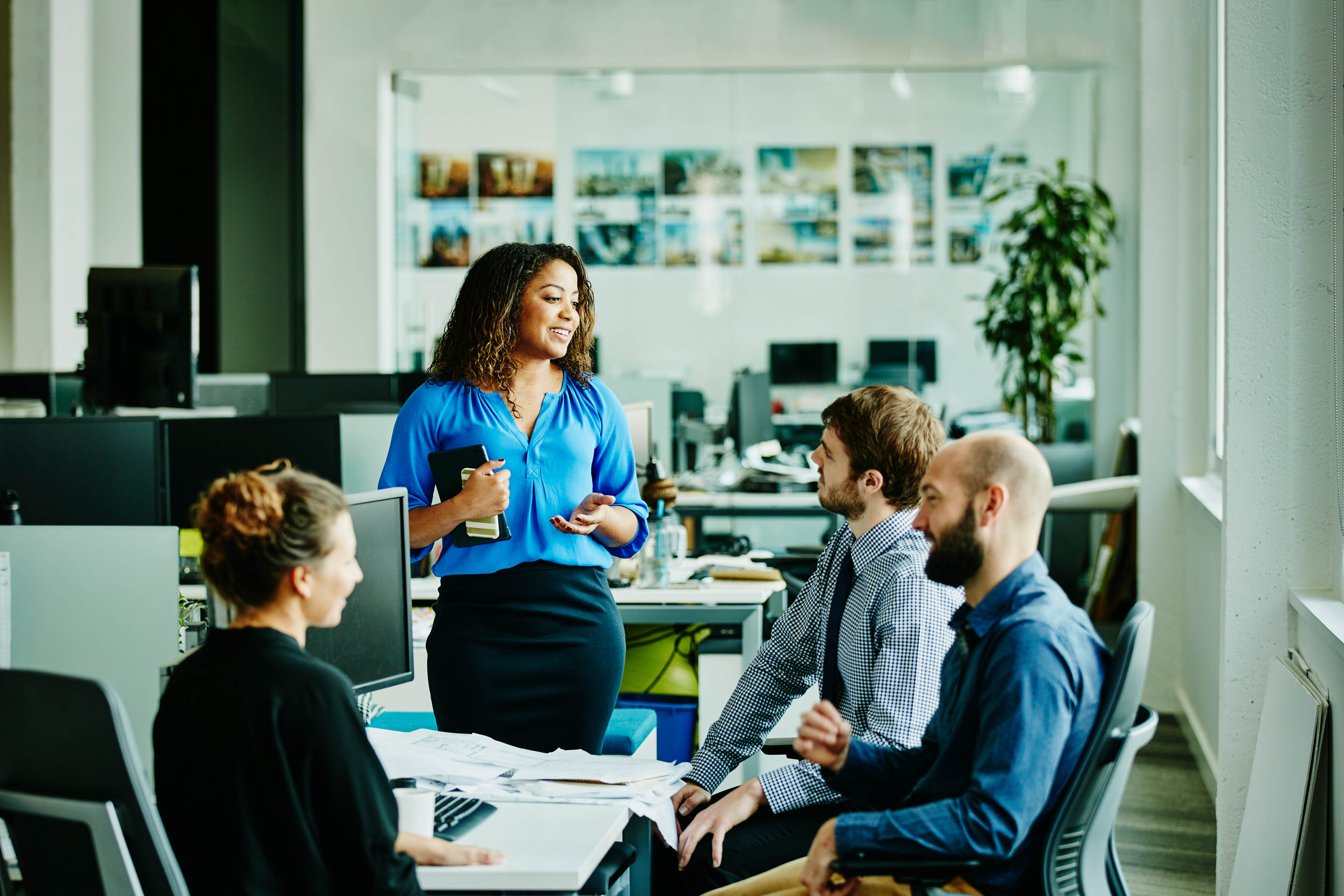 Businesswoman leading meeting with colleagues