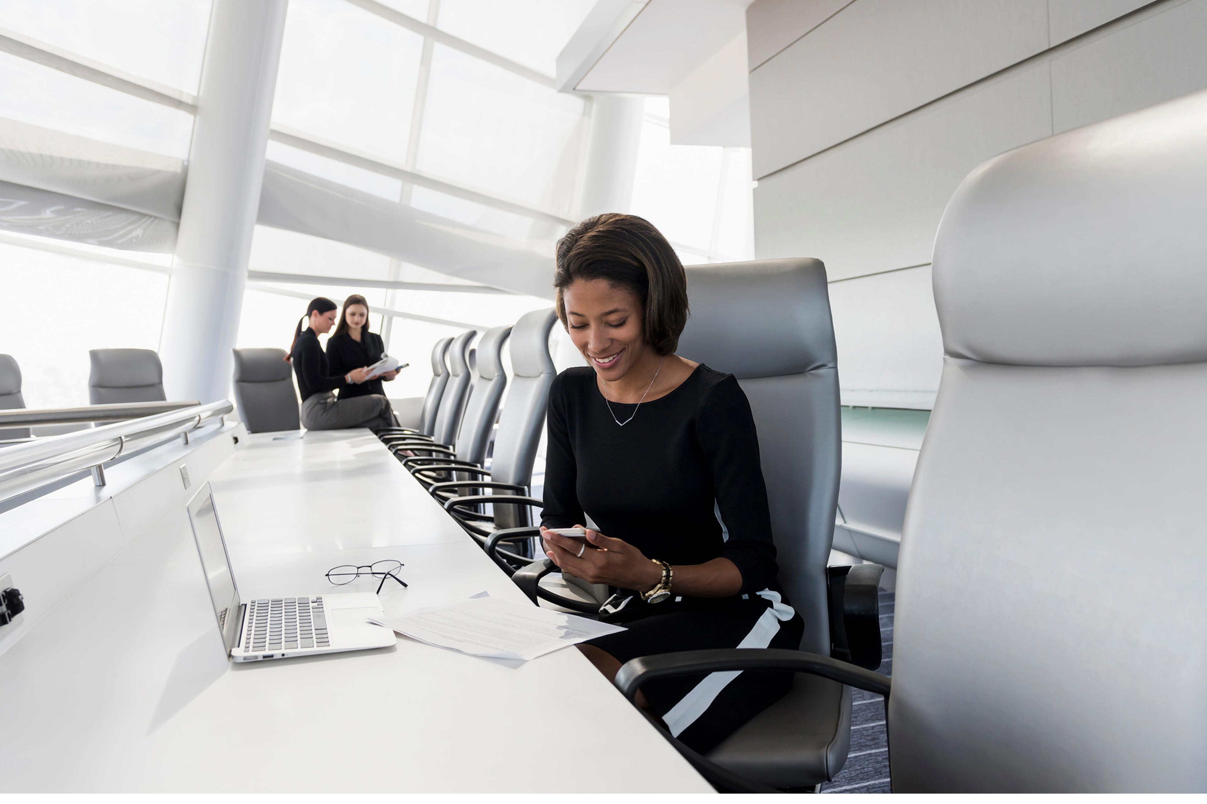 Business woman with cellphone in a conference room