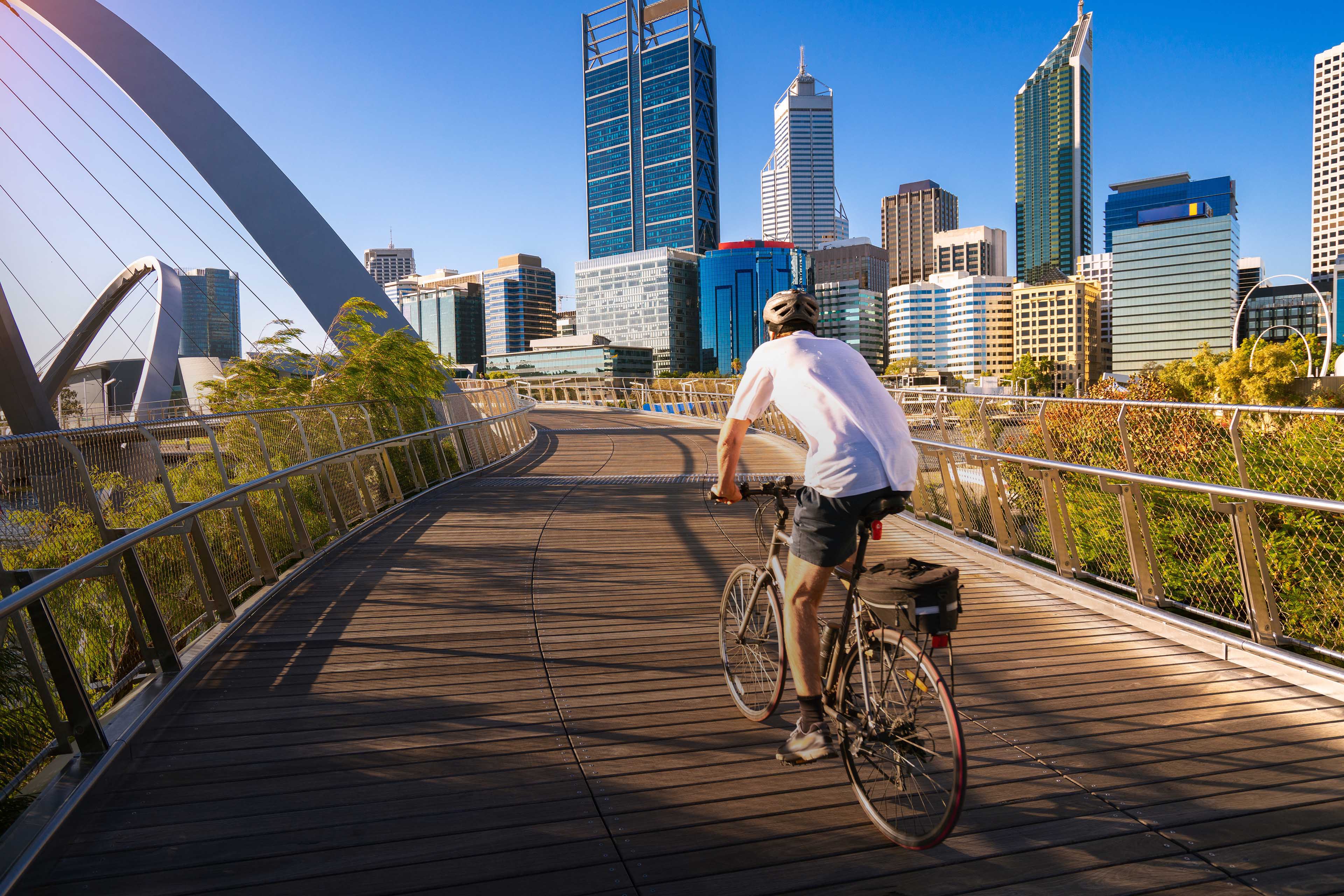 Man cycling on elizabeth bridge in Perth city