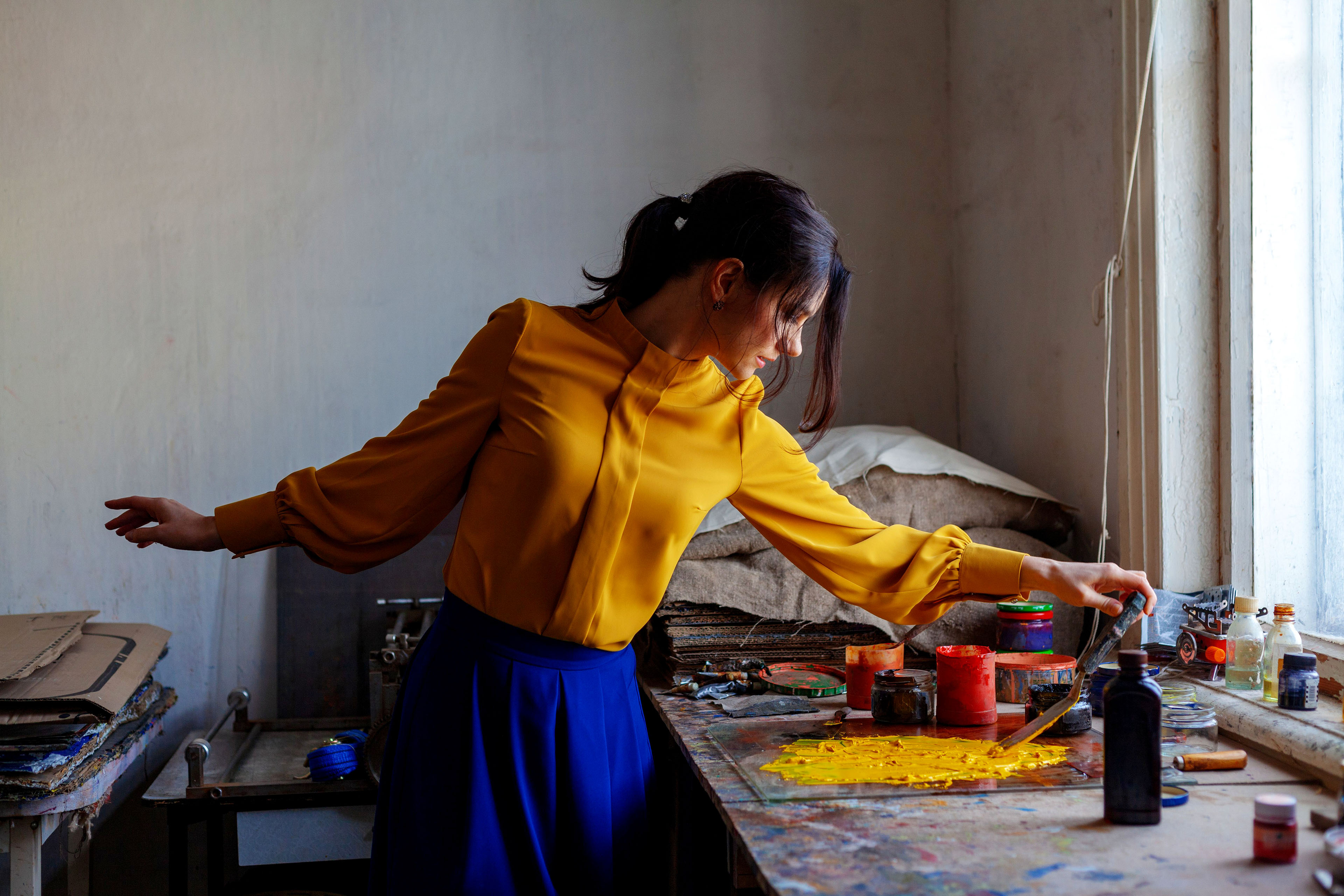 Woman creating art with scraper