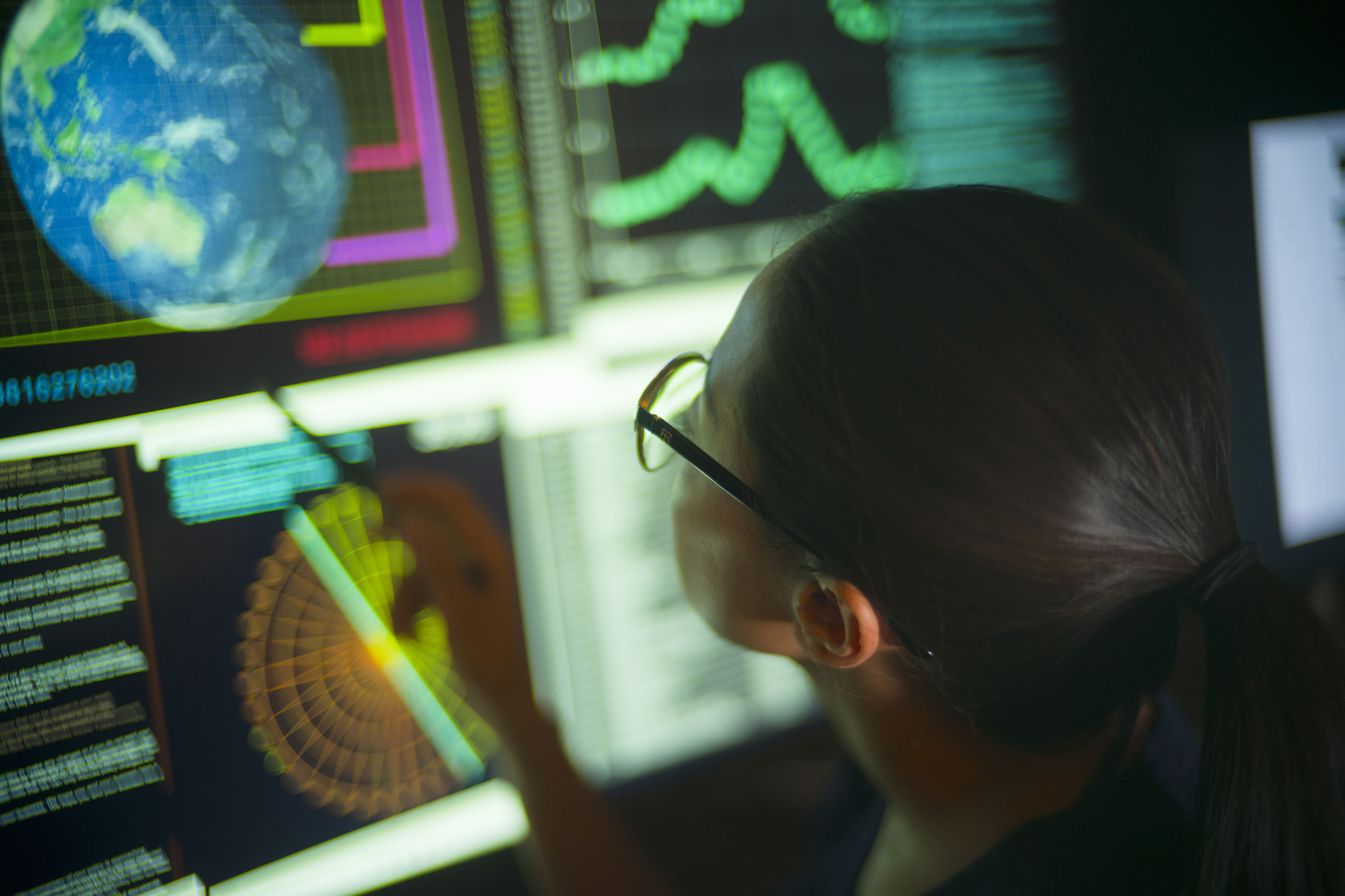 Woman studying global data on her computer