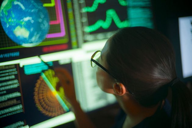 Woman studying global data on her computer