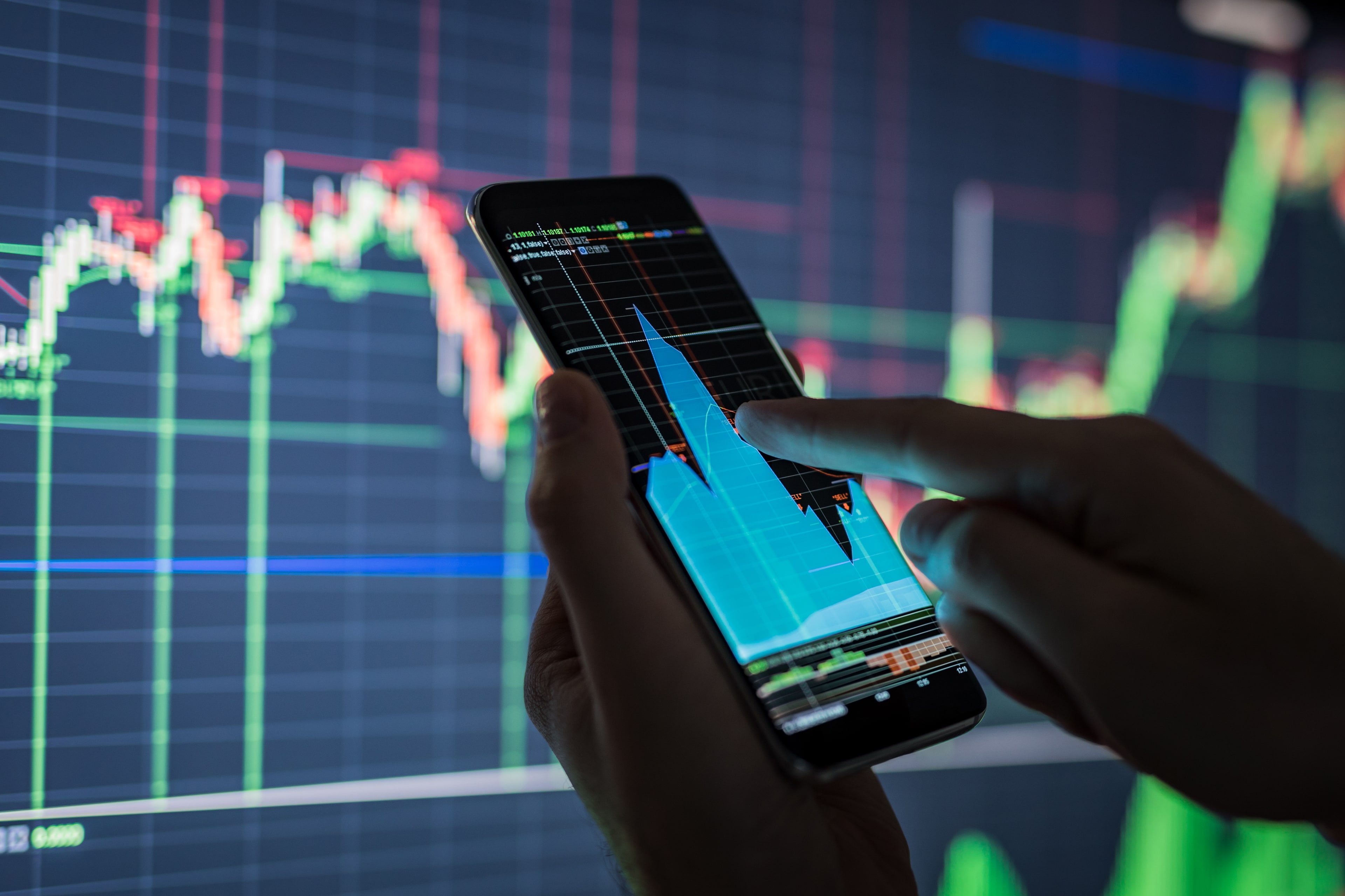 EY businessman checking stock market data background