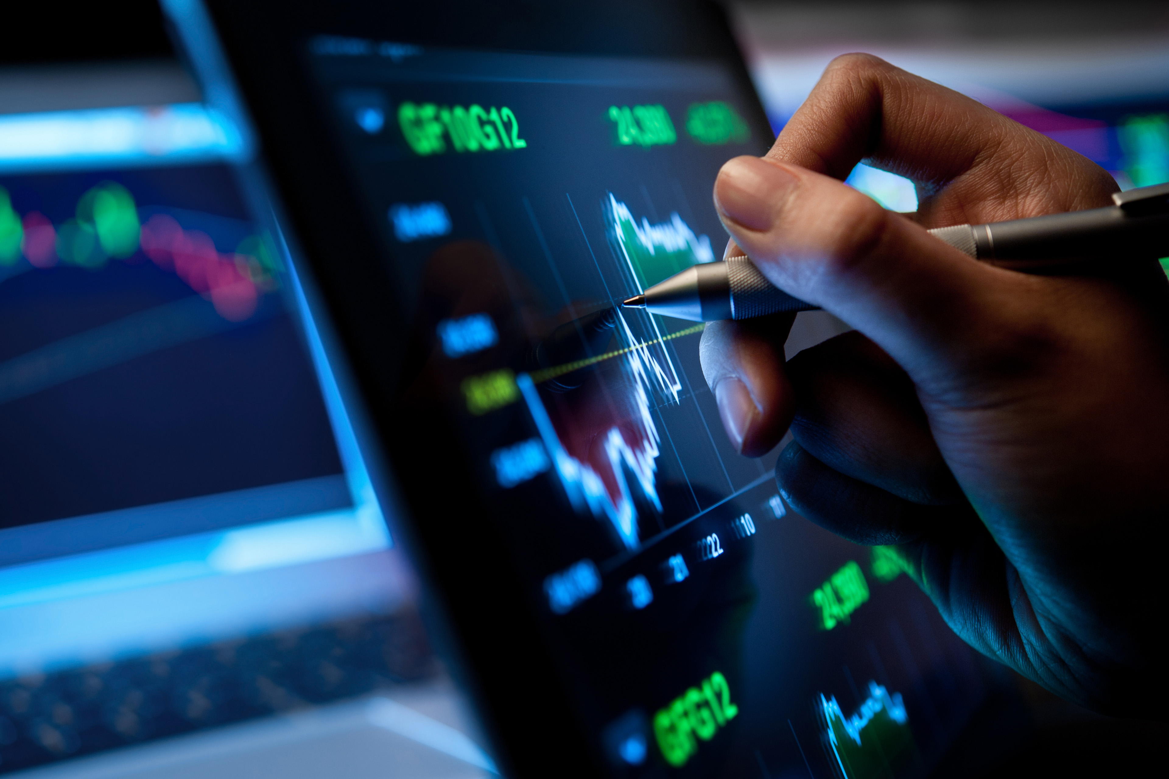 Market Analyze with Digital Moniter focus on tip of finger.