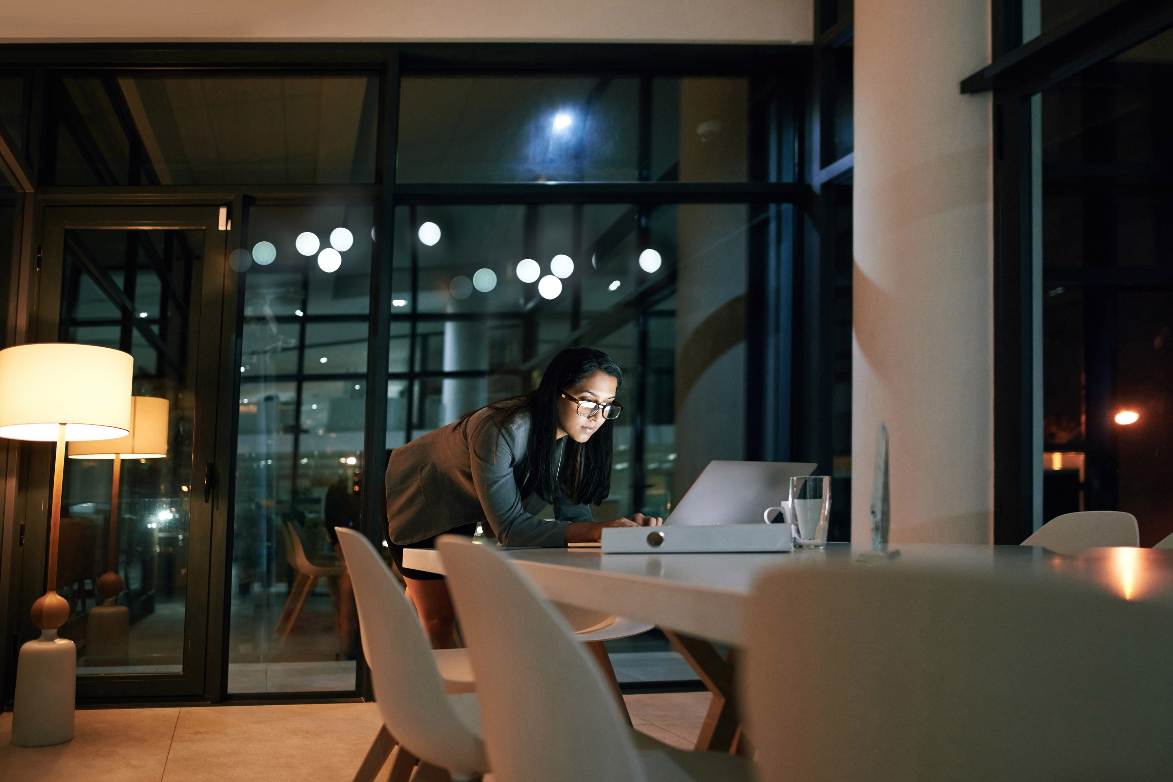 Businesswoman using her laptop while working at the office background