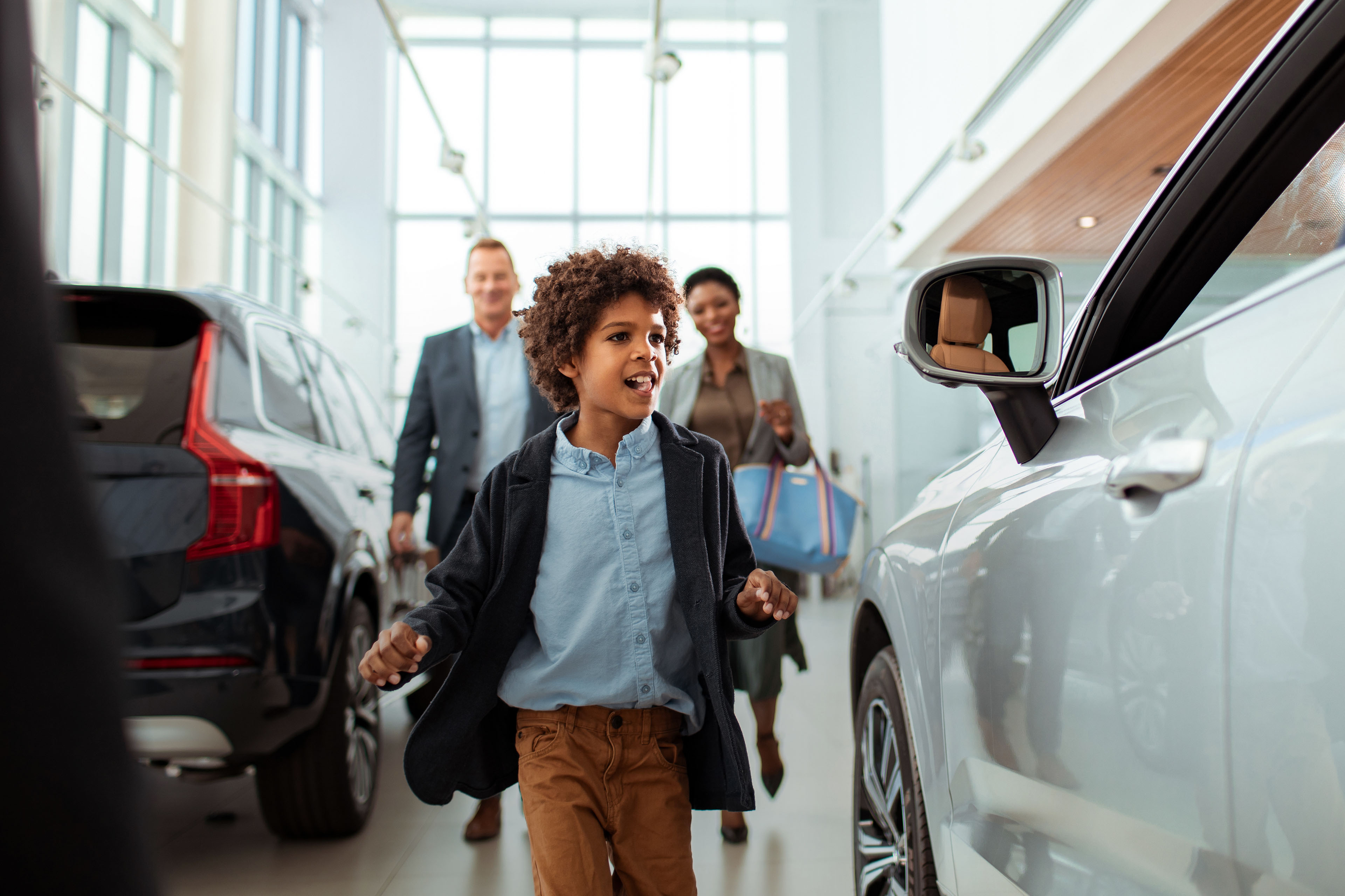 Family looking for their new car at the car dealership