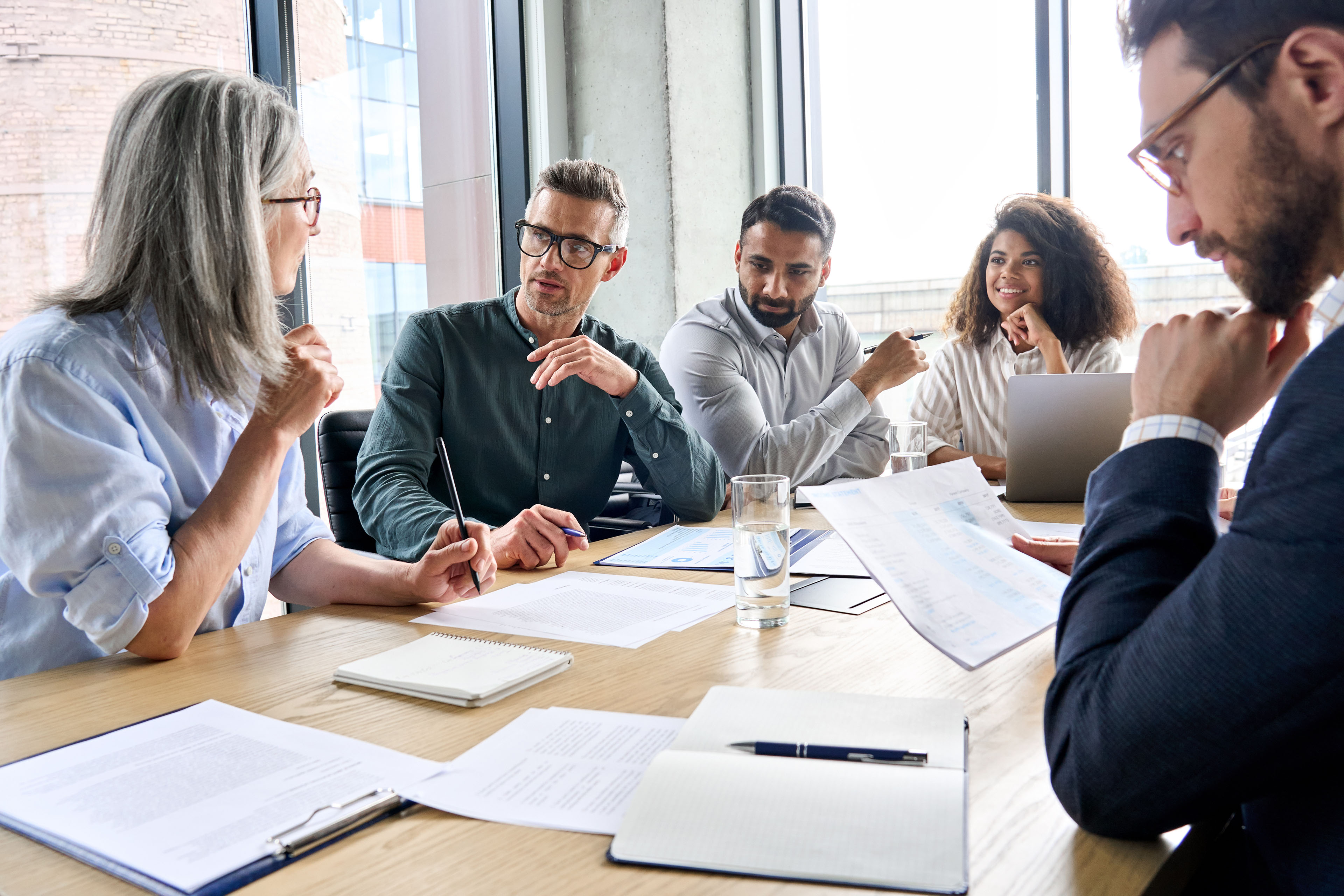 International business executive team having discussion at boardroom meeting