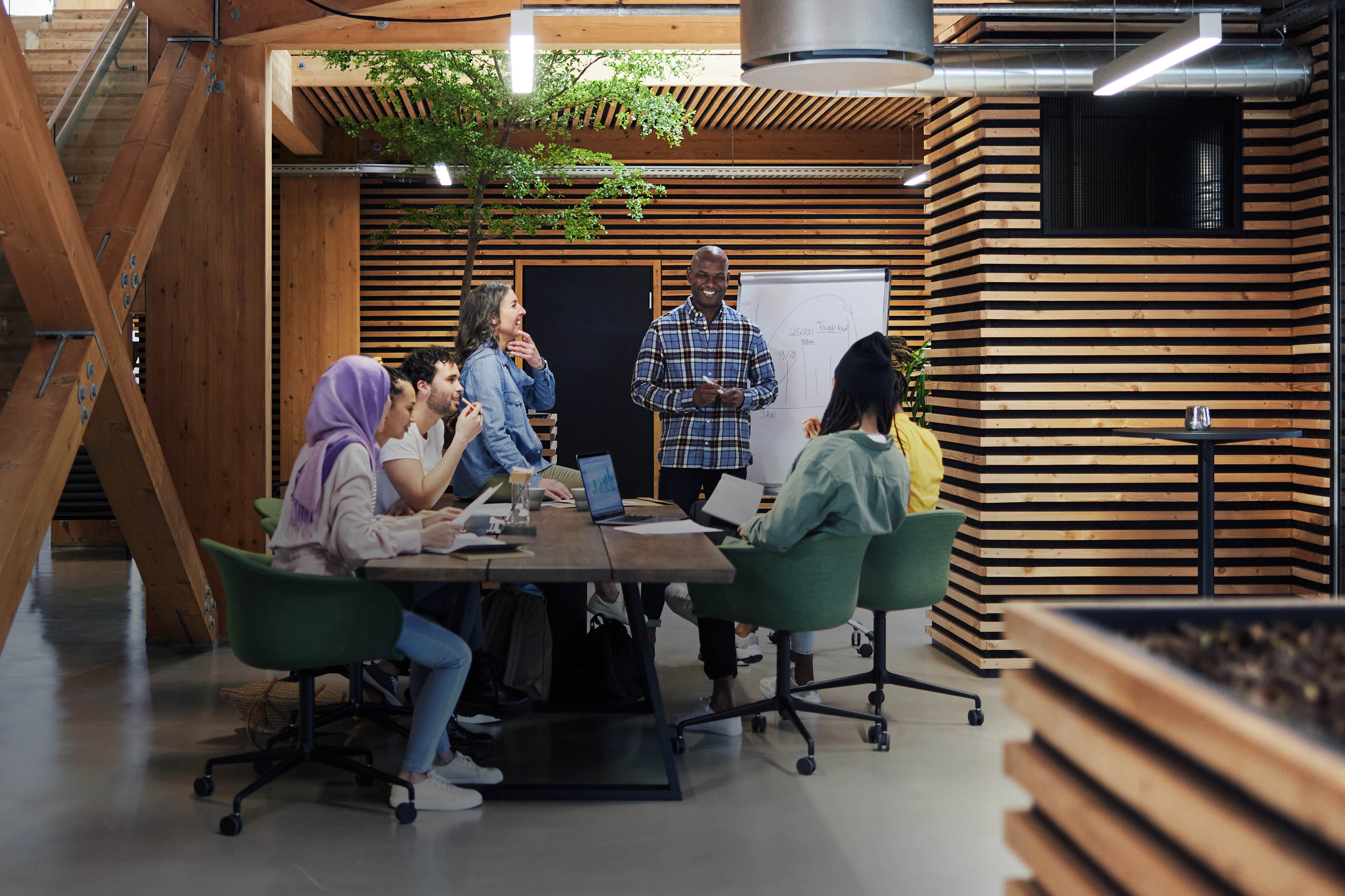 Diverse businesspeople smiling while having an office meeting