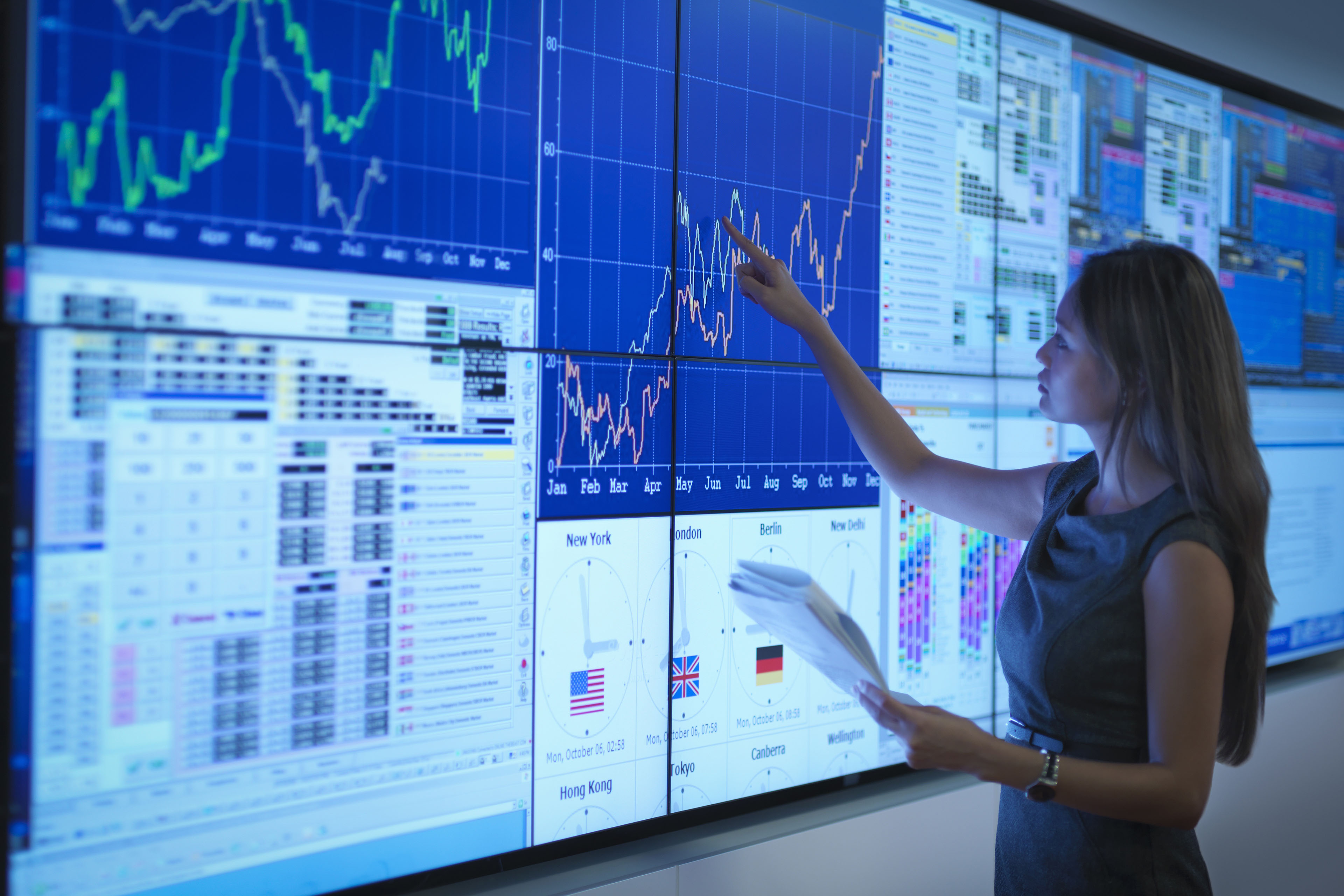 Businesswoman preparing presentation on graphical screens