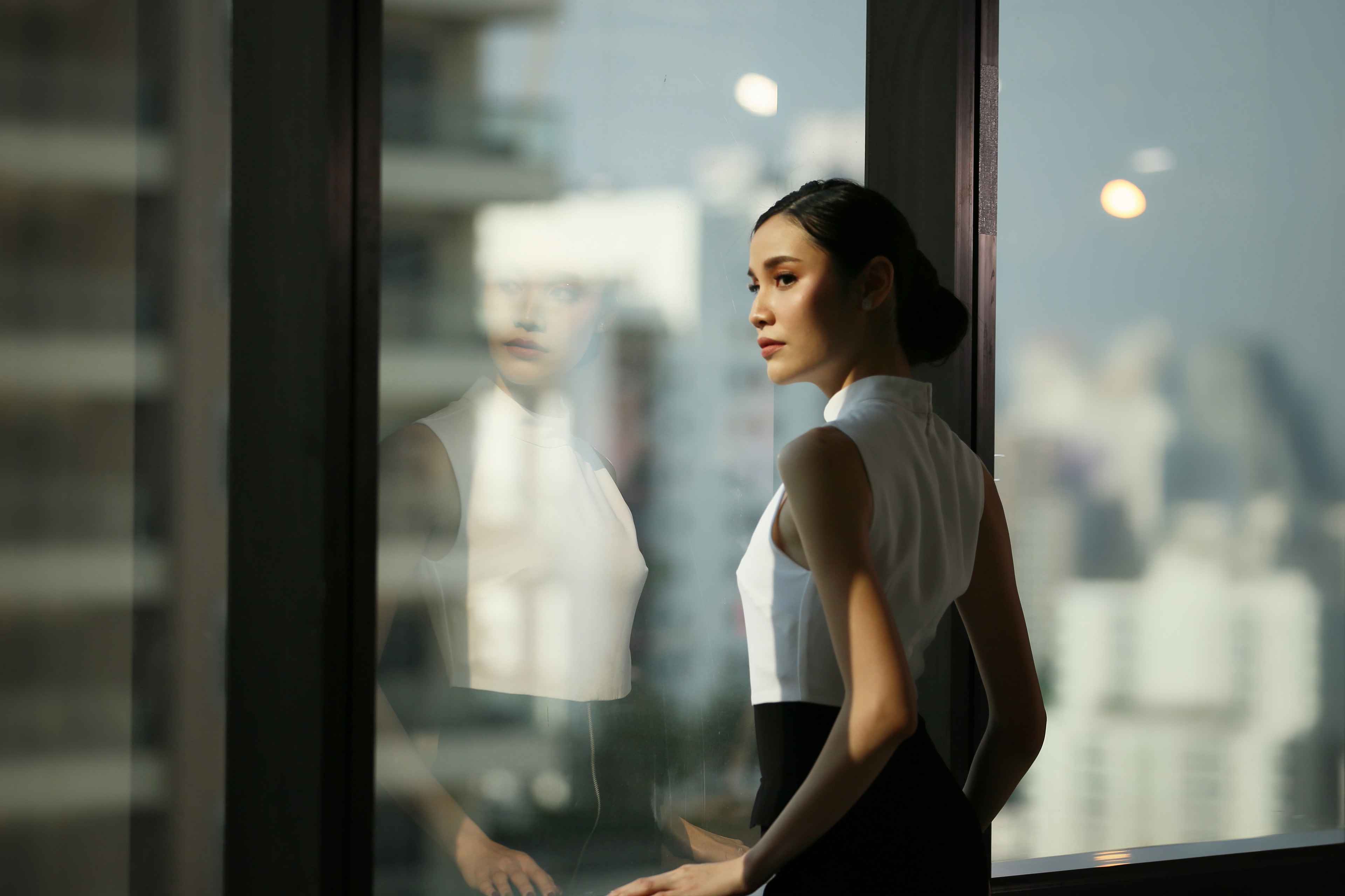 Businesswoman looking away standing by window