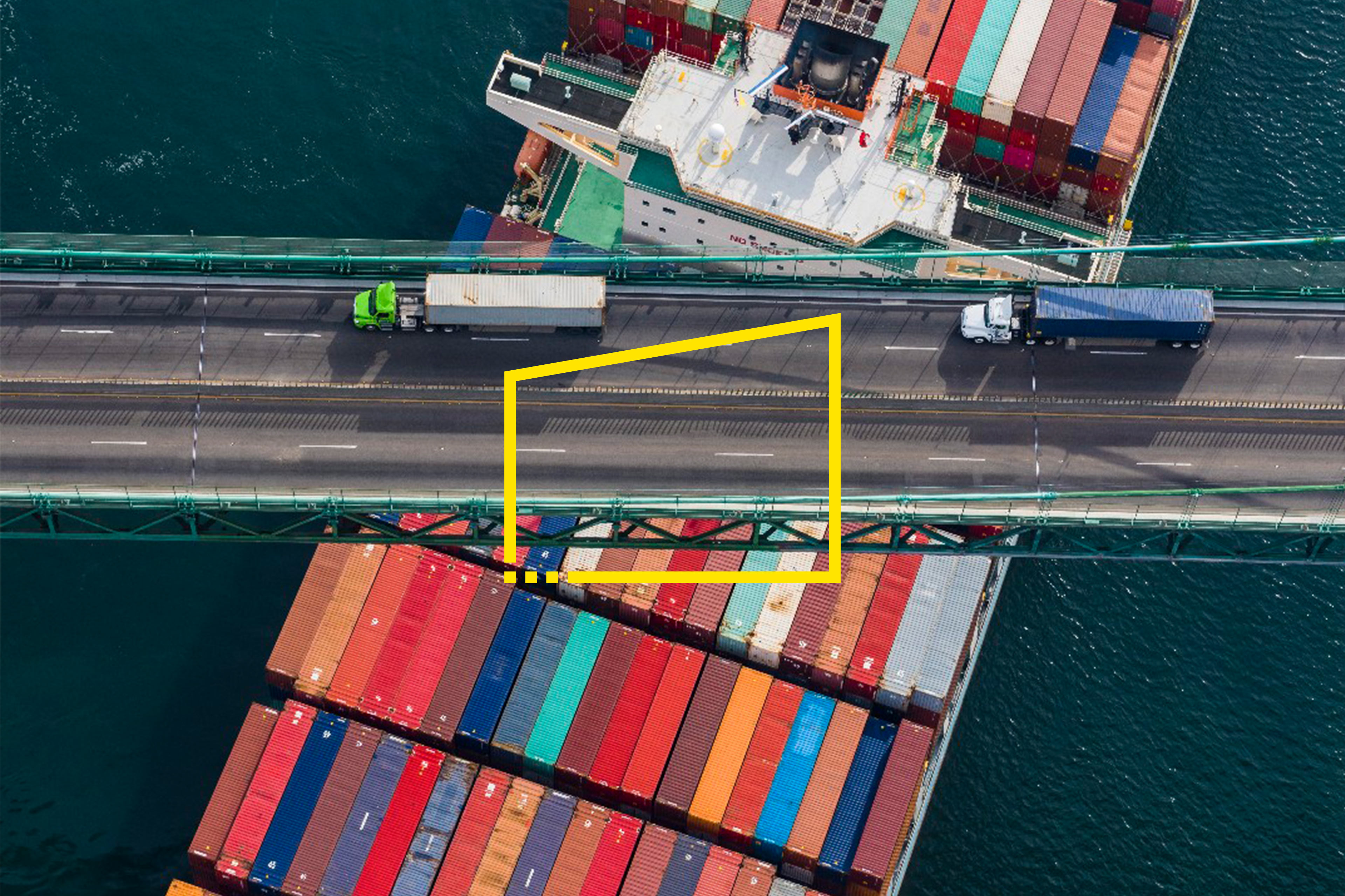 Aerial shot of two trucks driving across a bridge with Better Question frame overlay