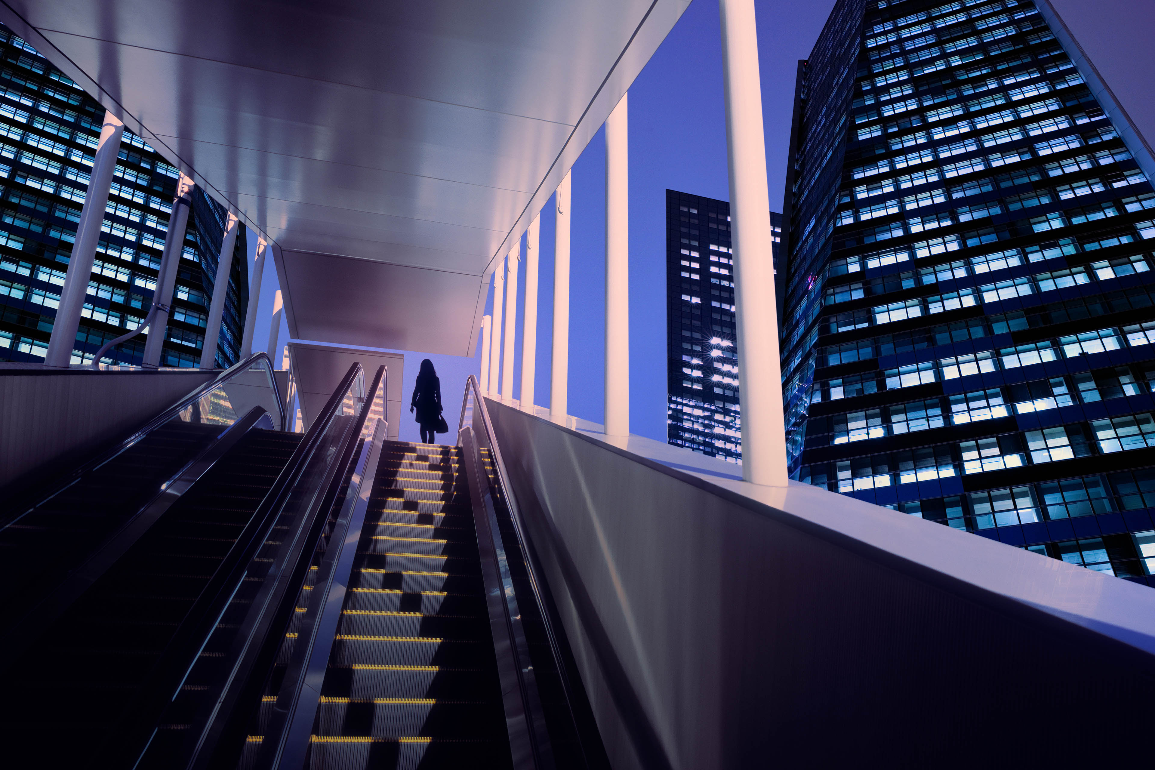 Businesswoman on top of a moving escalator