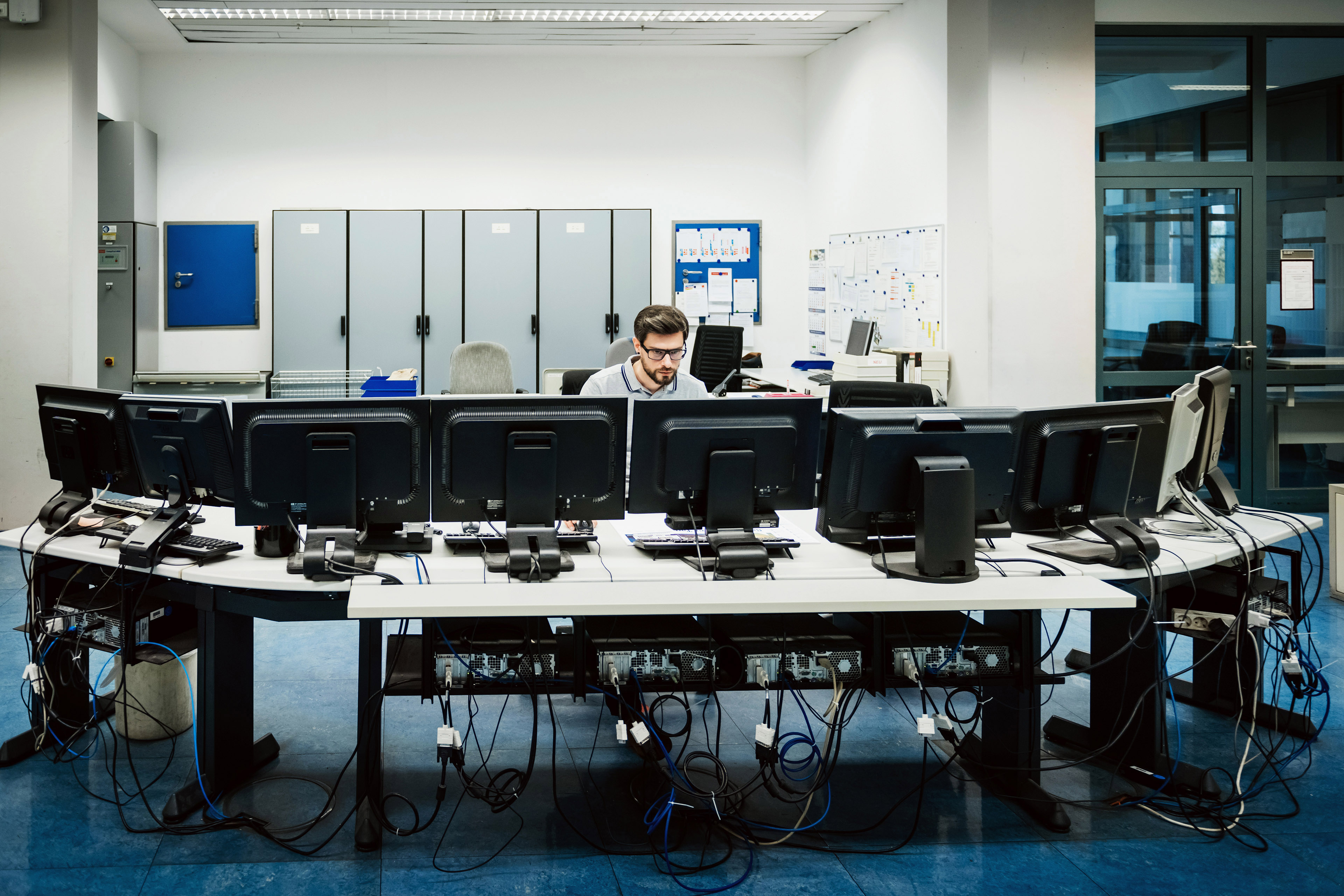 EY engineer working behind computers control room