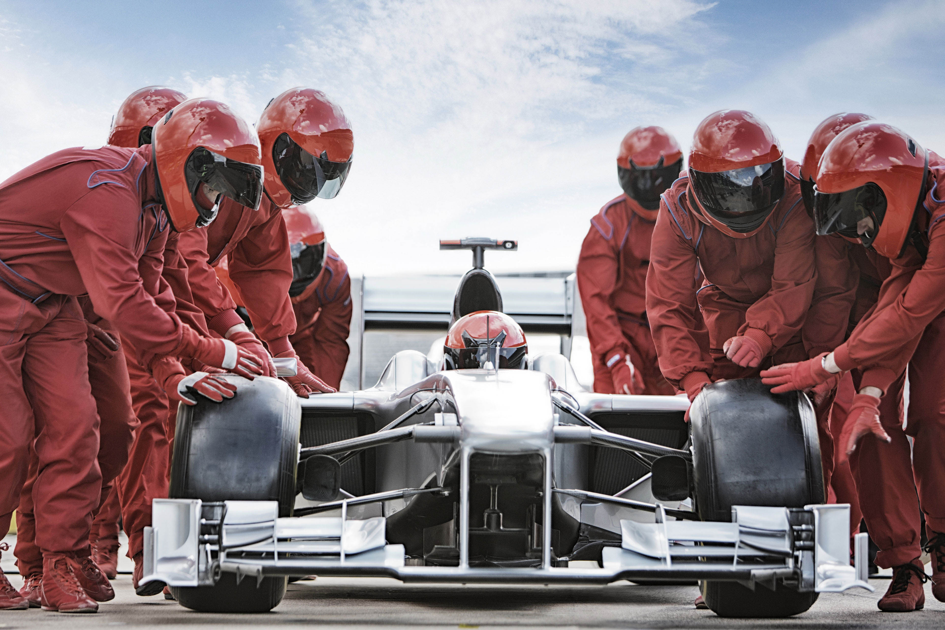 Racecar team assisting in pit