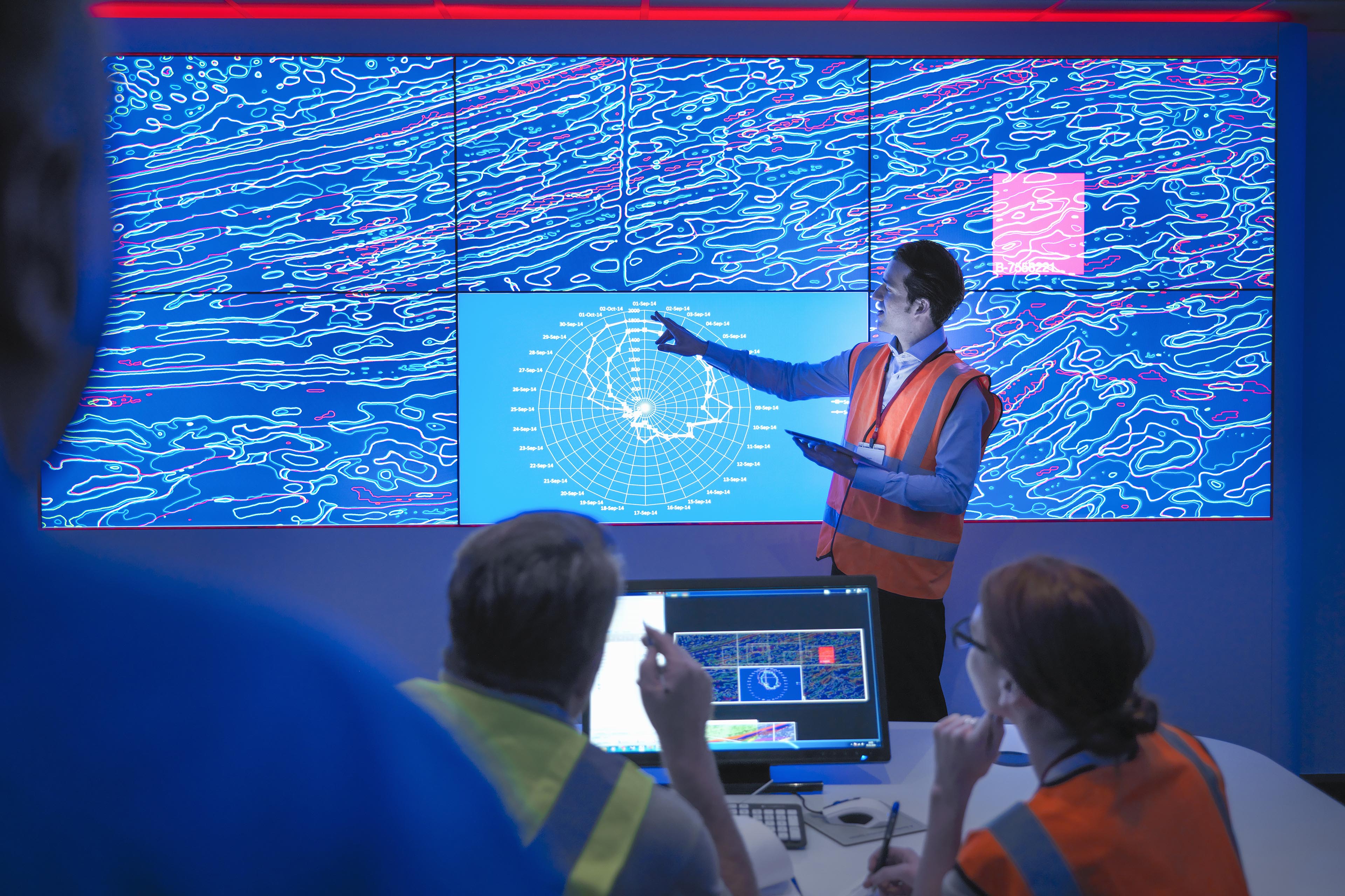 Geologists studying graphical display of oil and gas