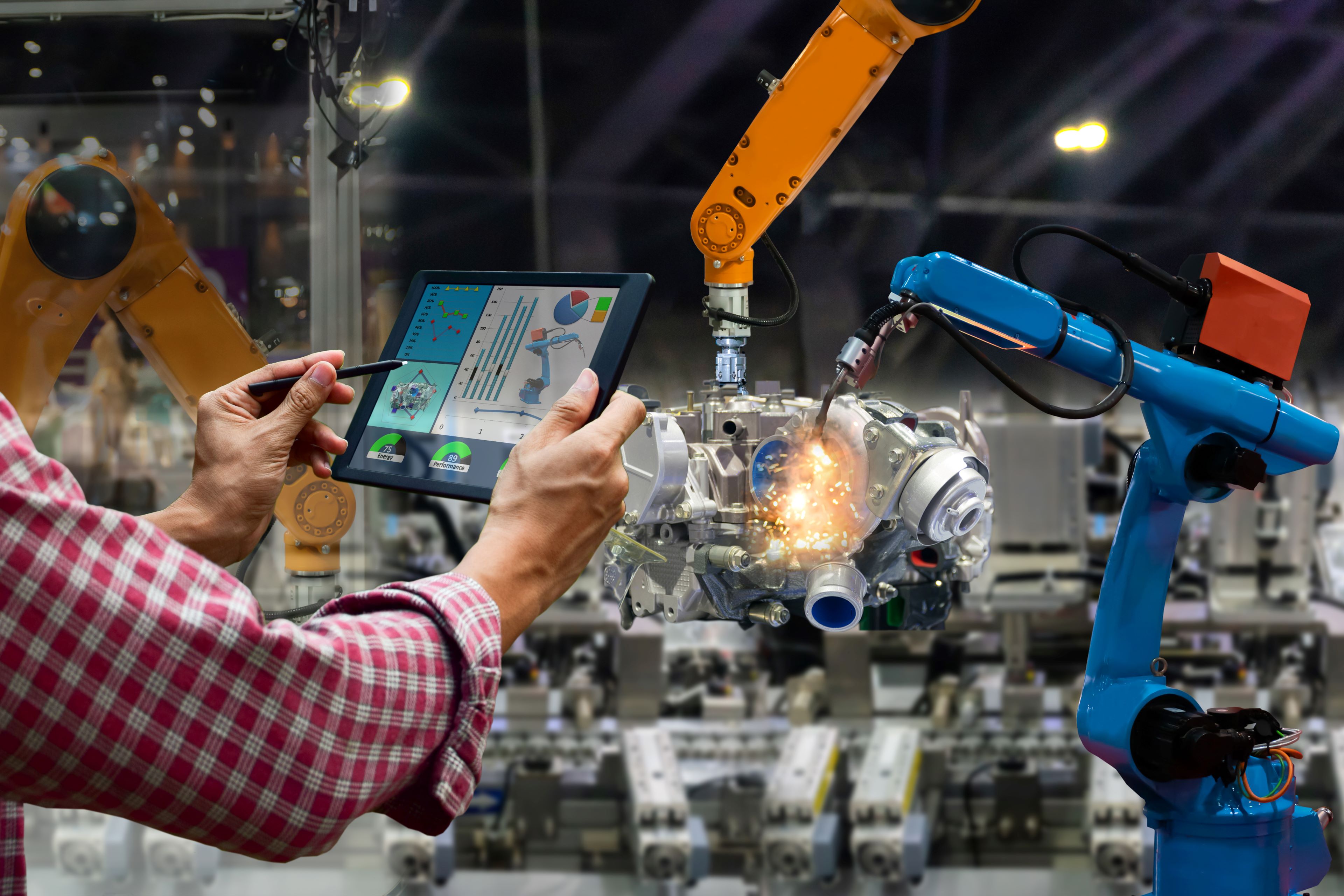 Man checking the performance of robot in Tablet.