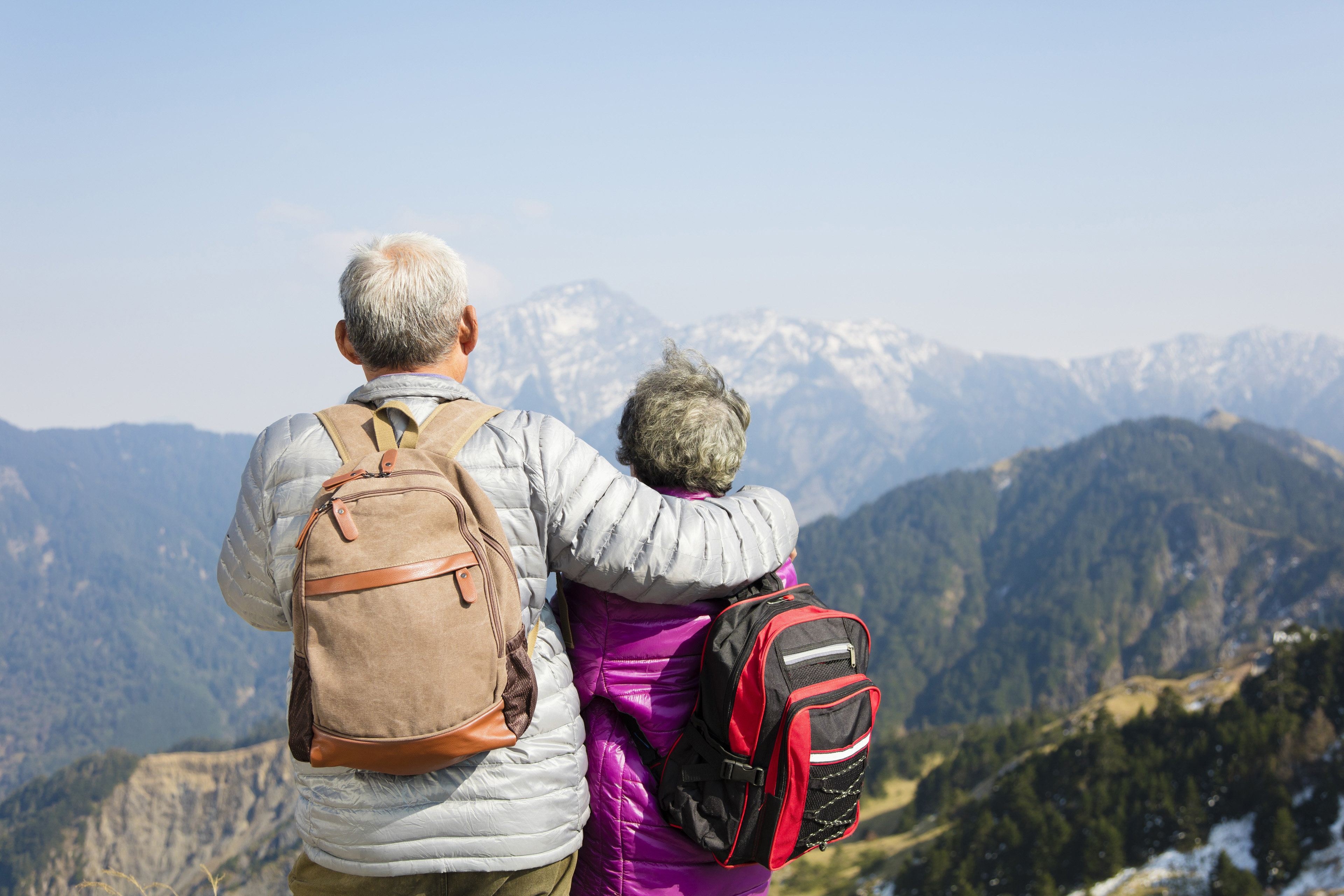 Rear view of senior couples watching mountains