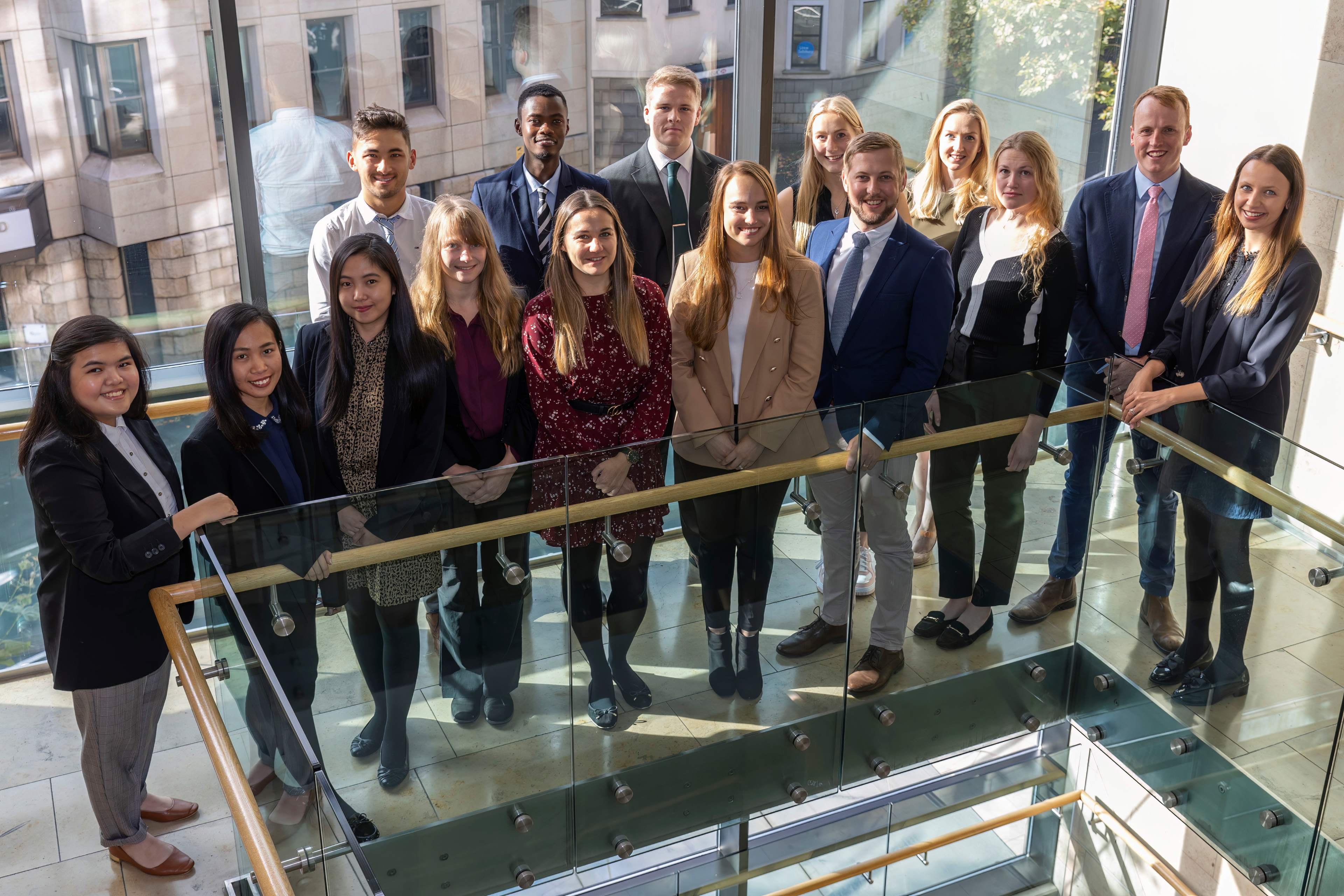 A group of people facing the camera in office