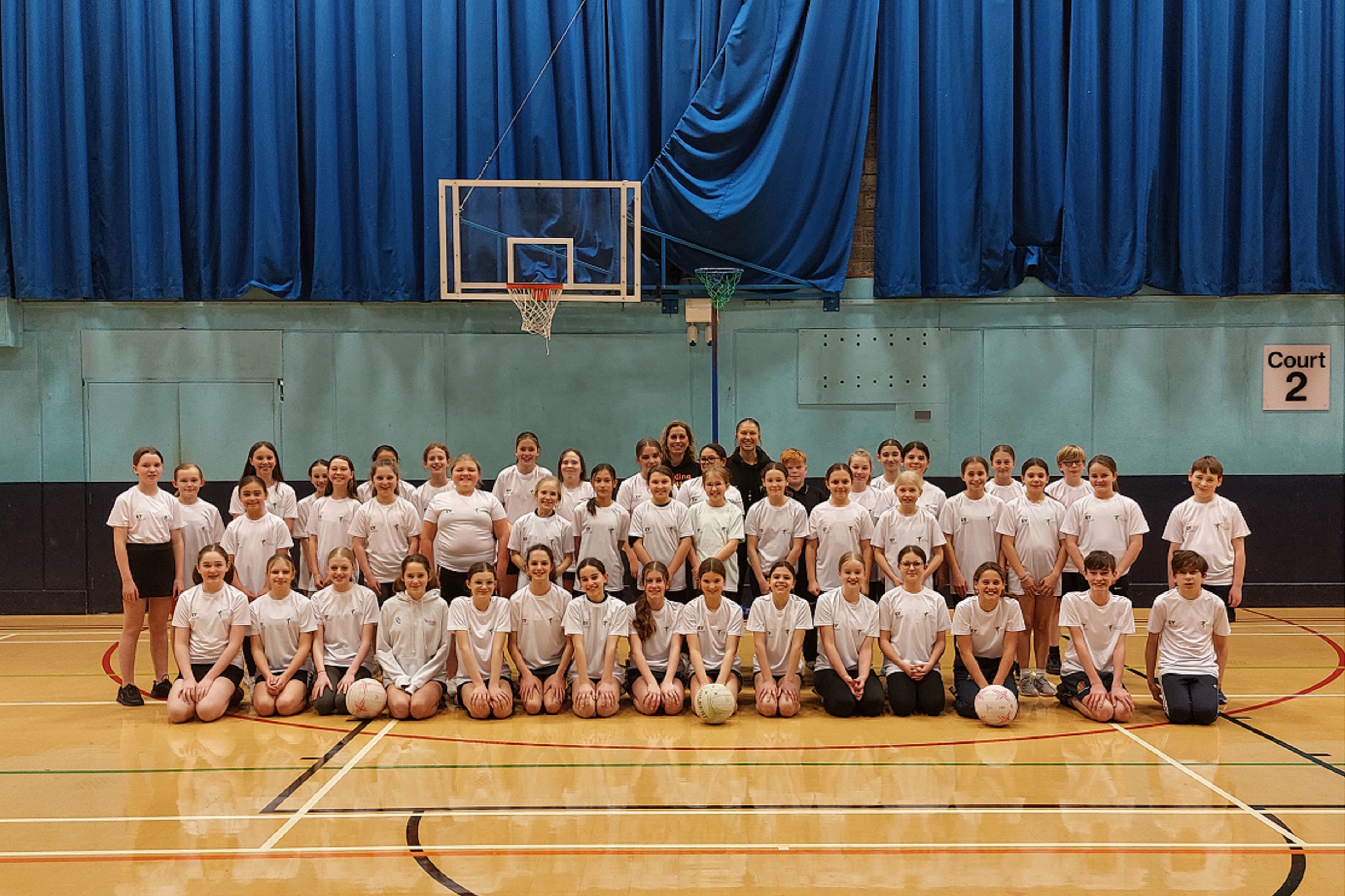 Photograph of Netball players with Fiona Morton