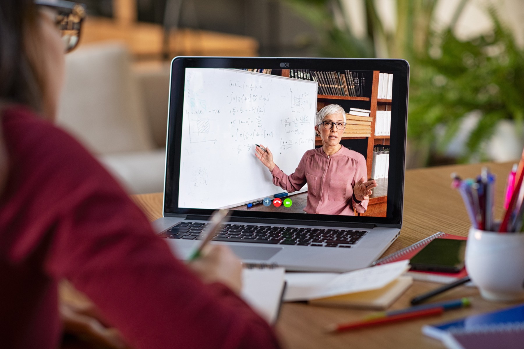 Young student watching lesson online and studying from home