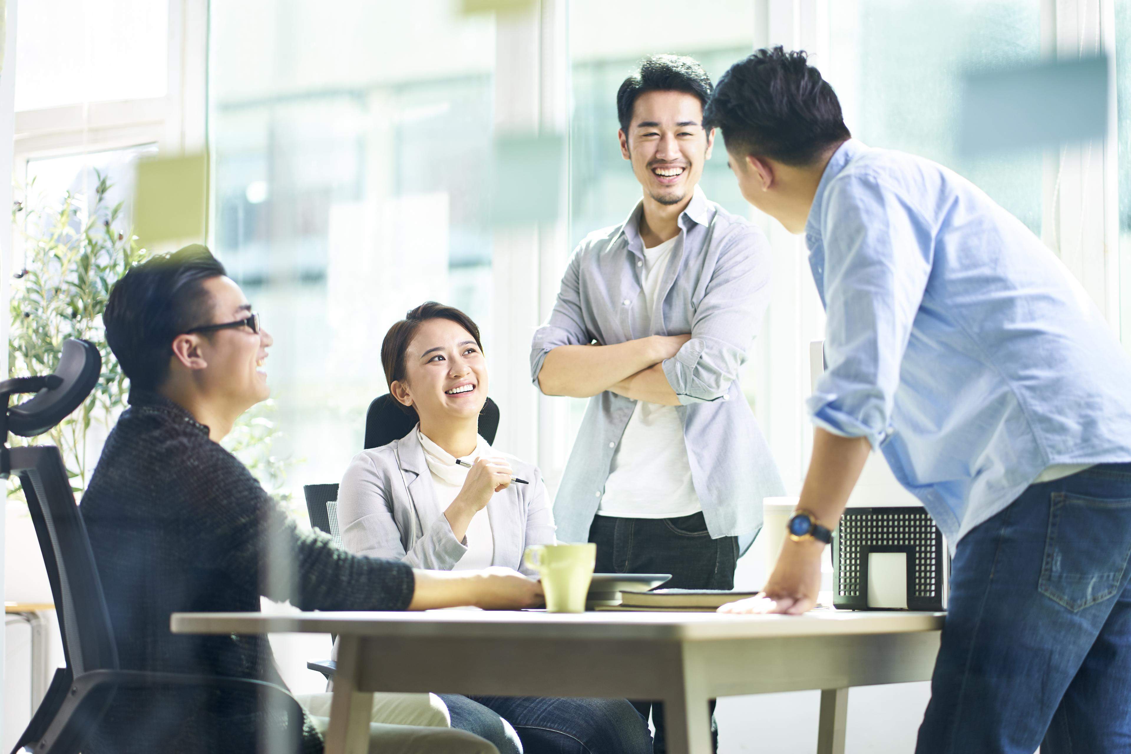 Asian Workers discussing business in office