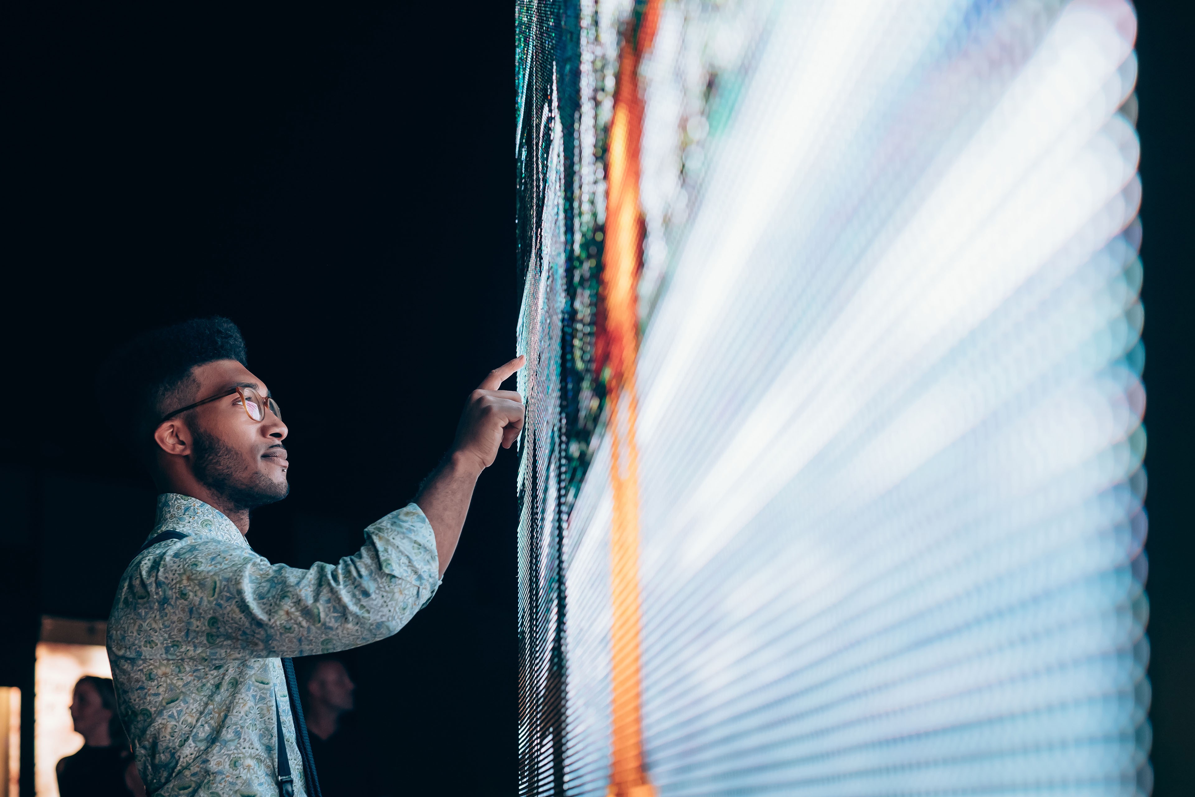 Businessman pointing at digital information board