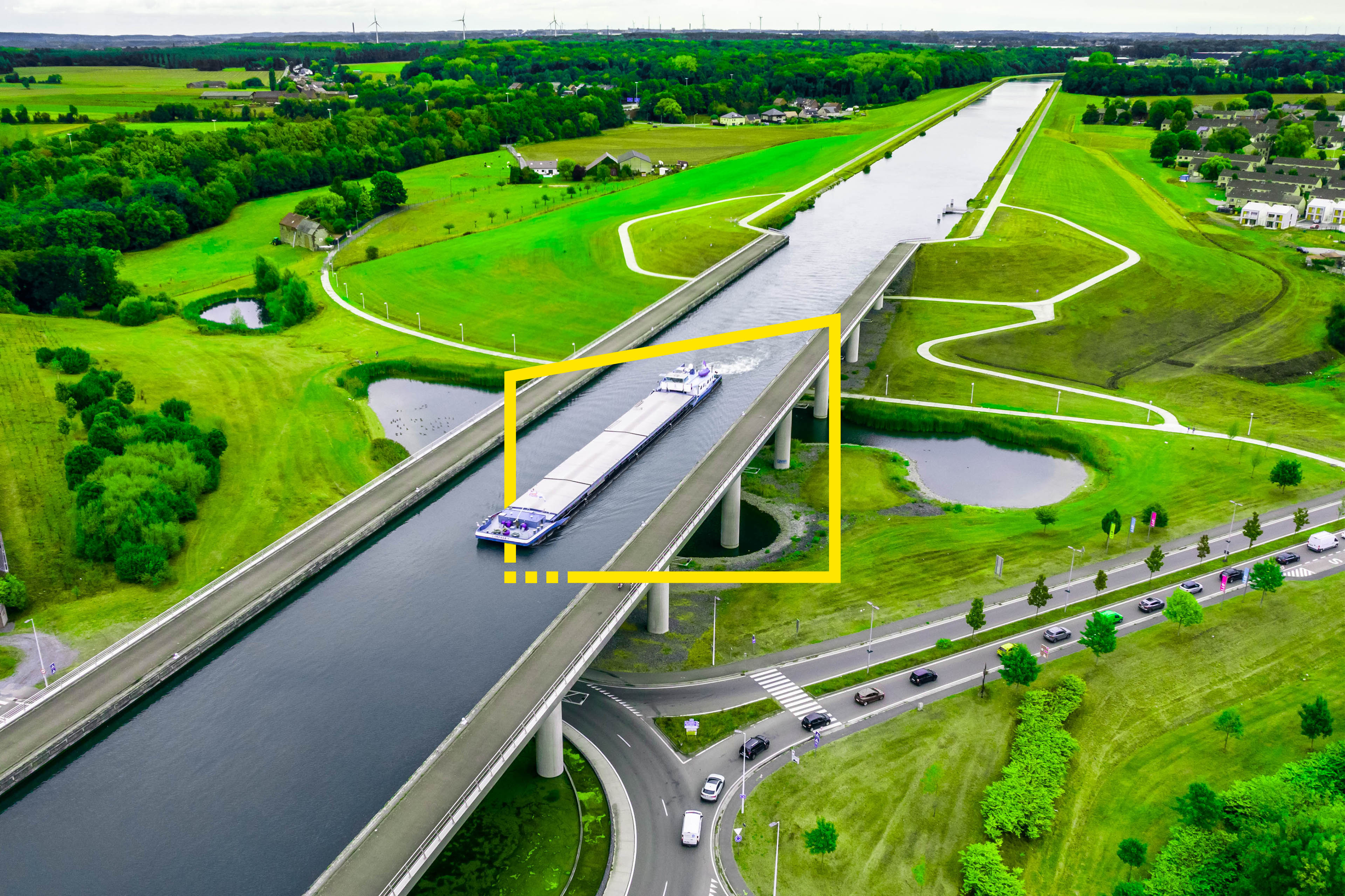 ey-aerial-view-of-the-sart-canal-bridge-crossing-road-in-the-green-landscape-of-belgium-static-no-zoom