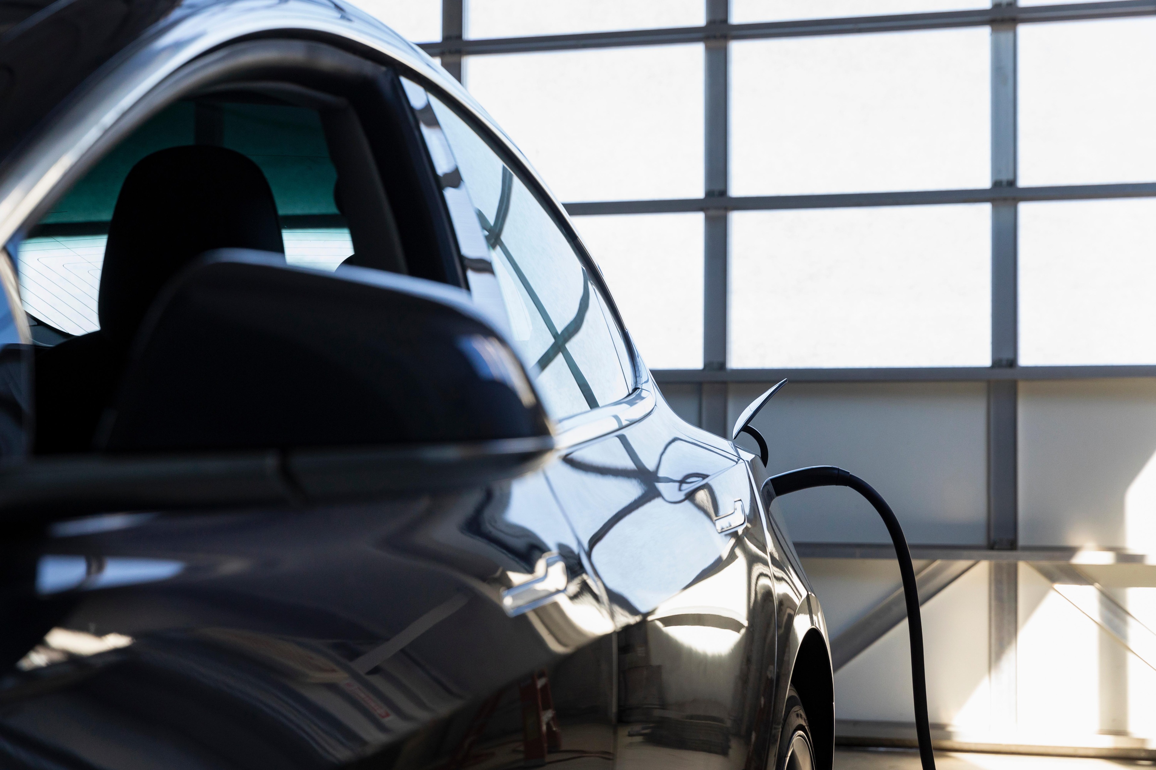 Electric car charging at home in modern garage