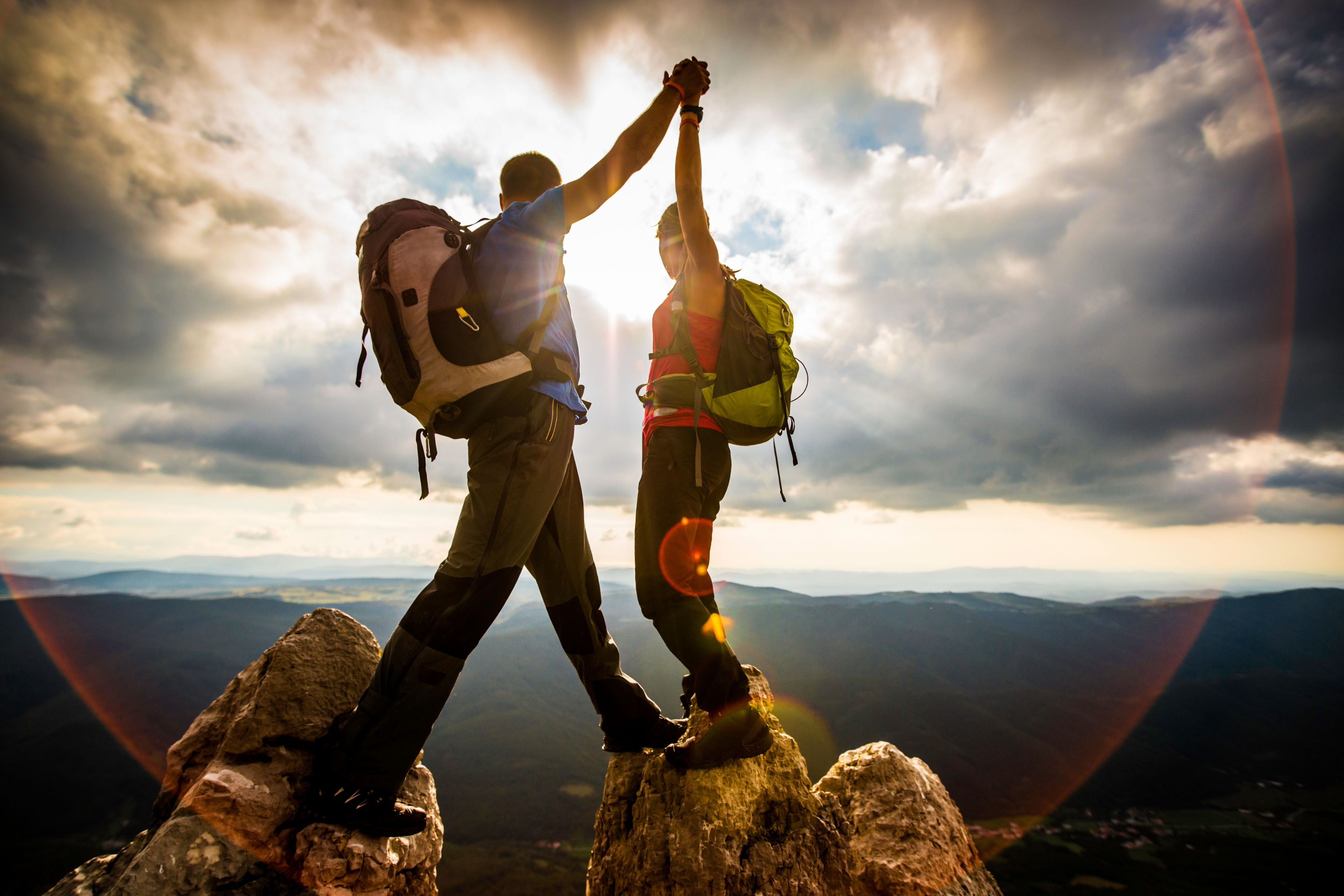 Alpinists celebating on the top of the mountain