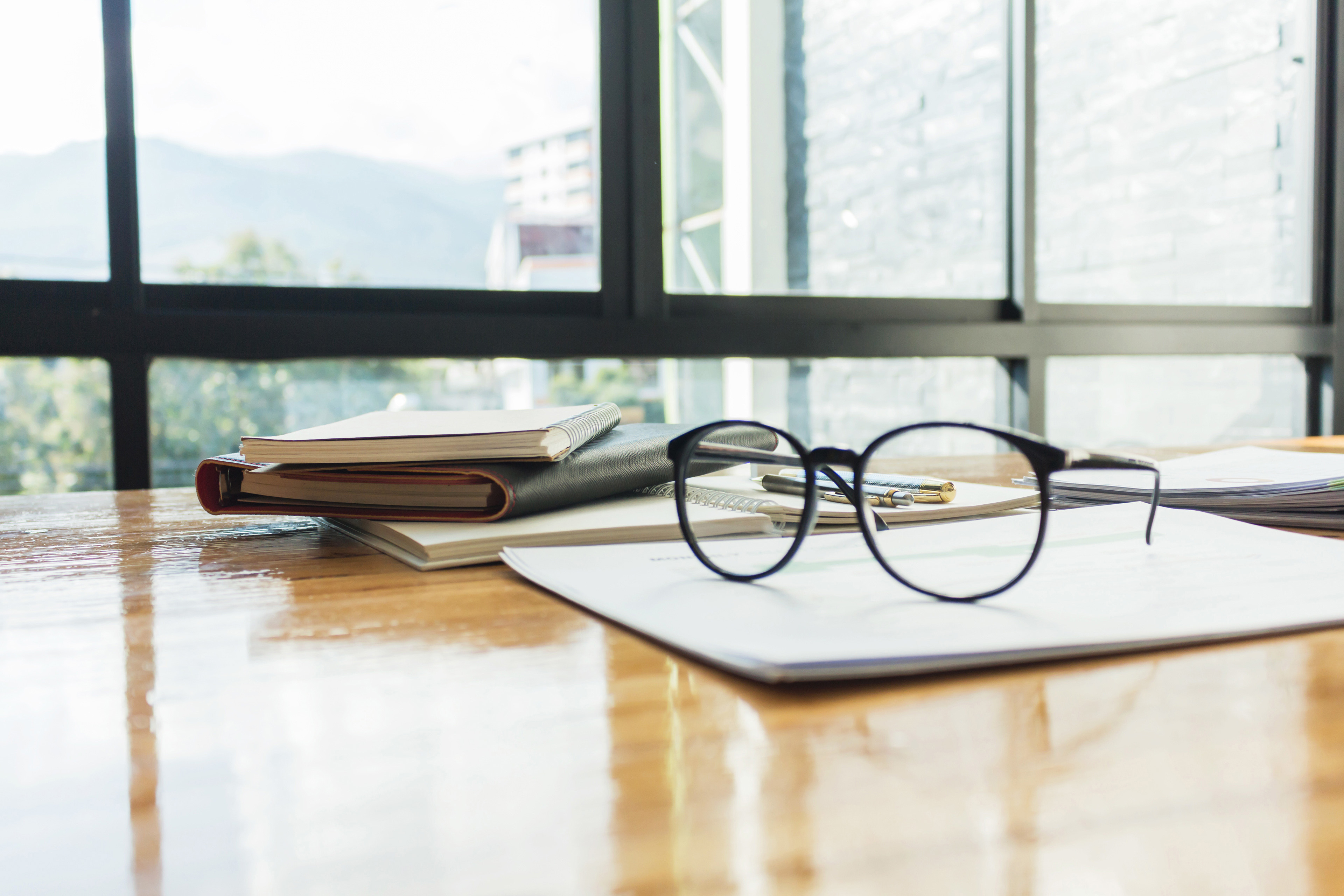 Glasses with documents on the table 