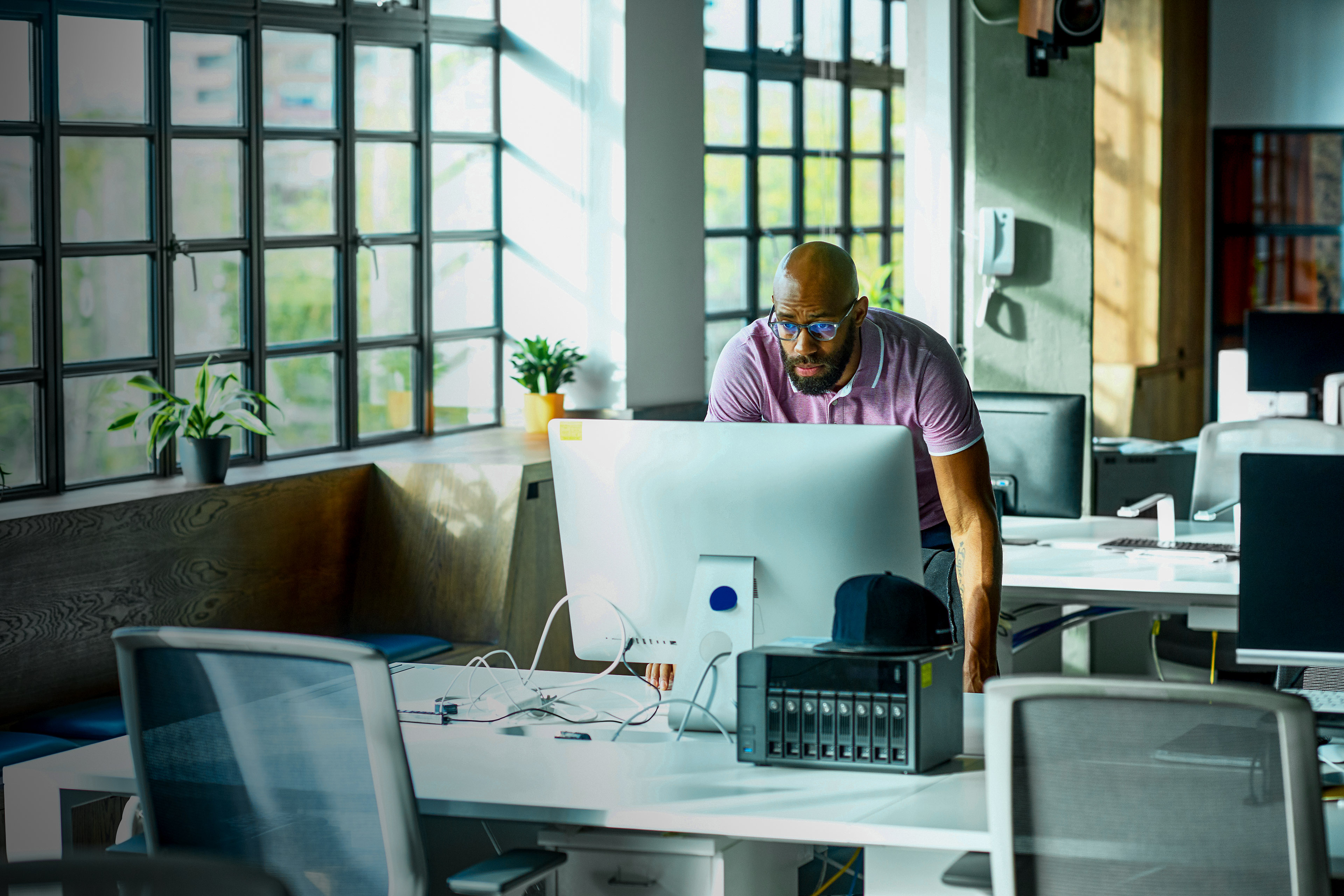 Ey man using computer at desk in office