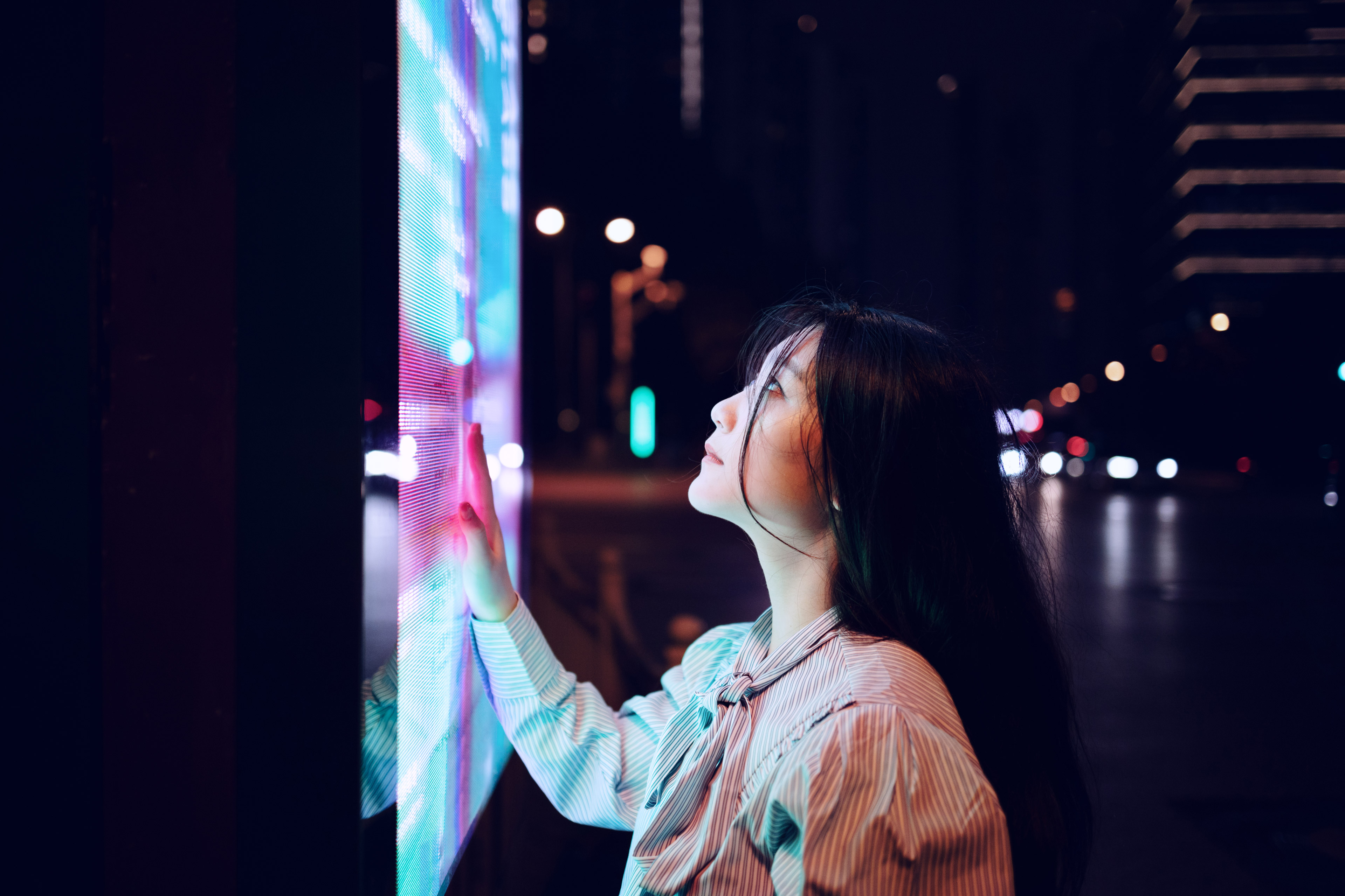 Young woman using touch screen on the street in shanghai china