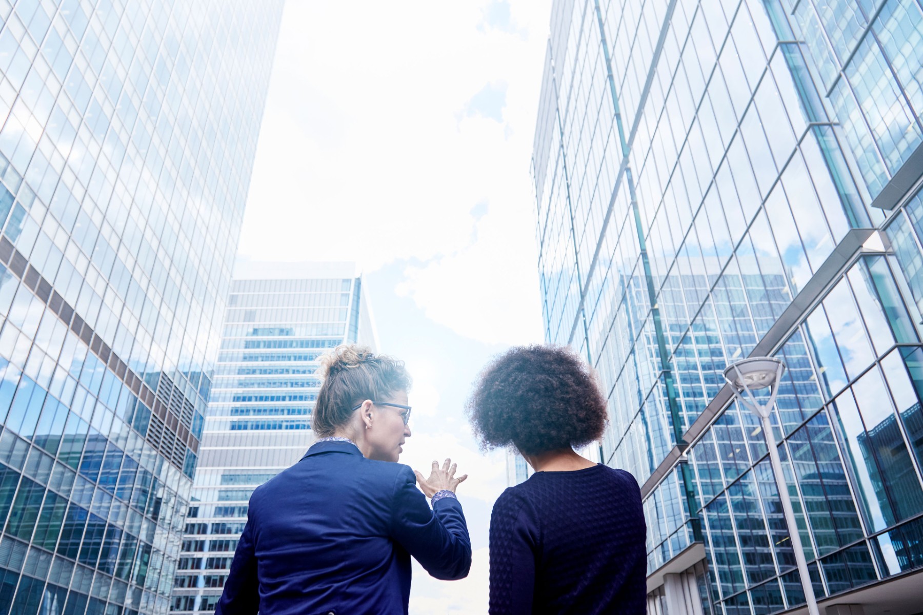 Two women near tall office buildings