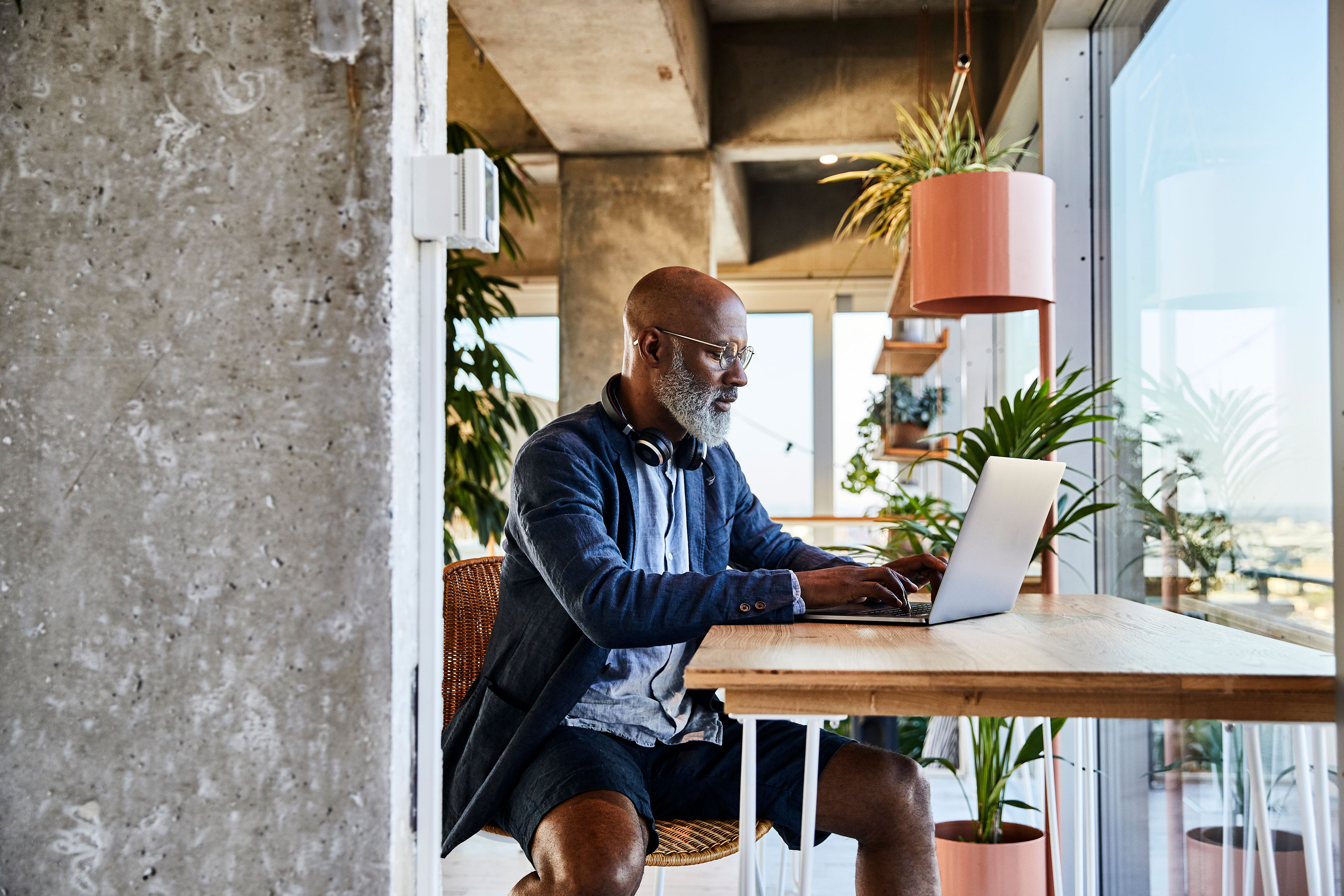 Mature man doing work from home while using laptop