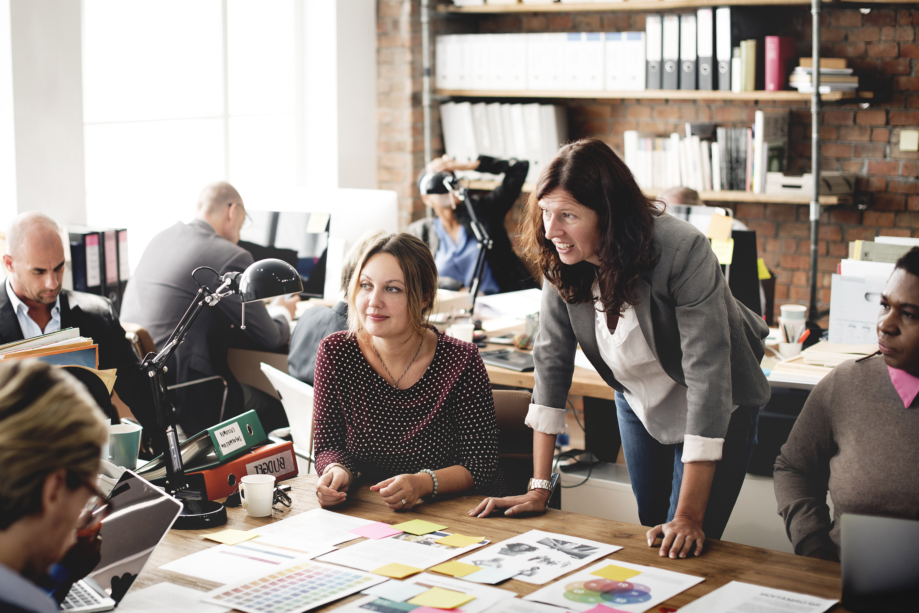 Employees having a discussion while having coffee