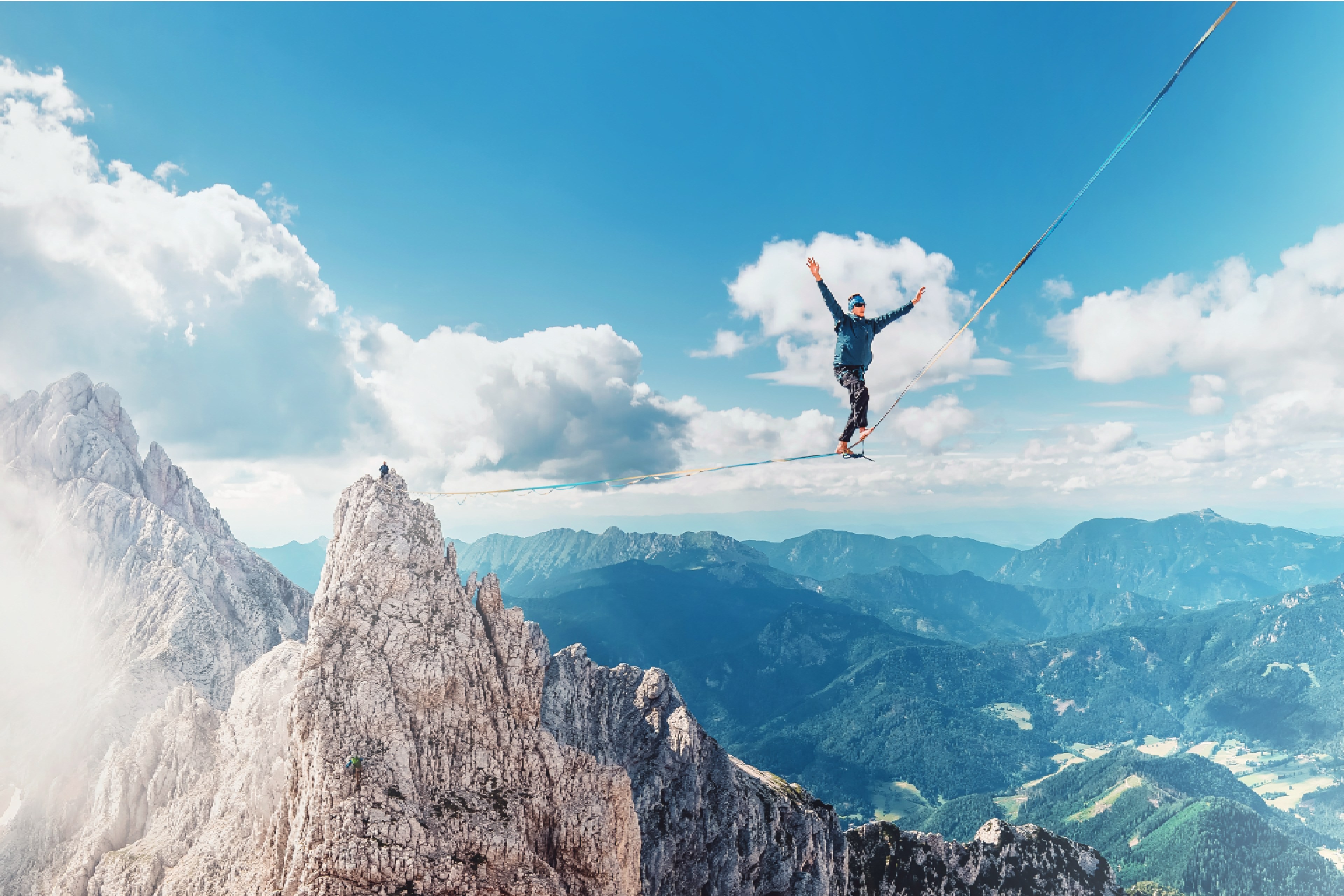 EY man walking on slack line in mountains