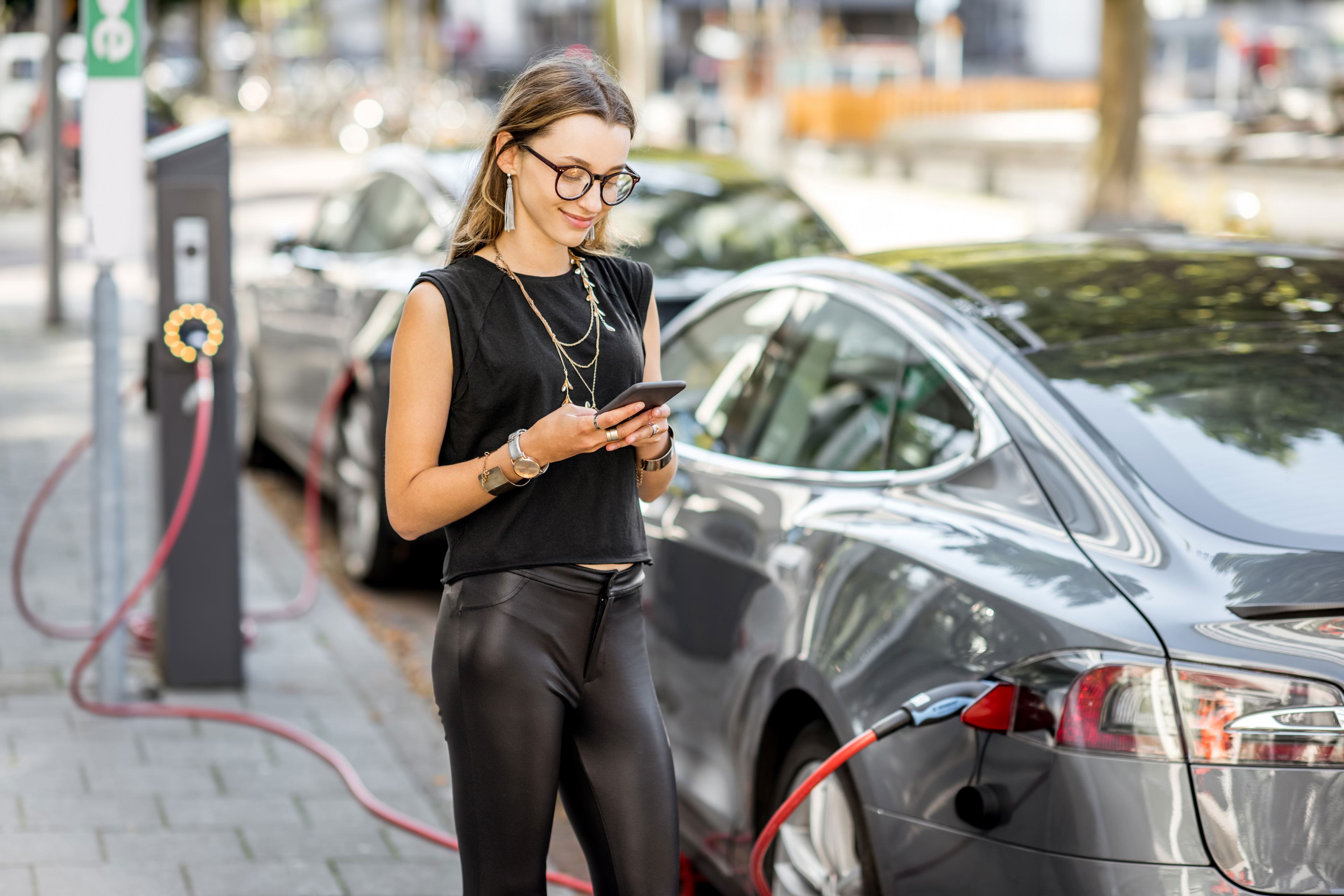 Woman charging her electric car