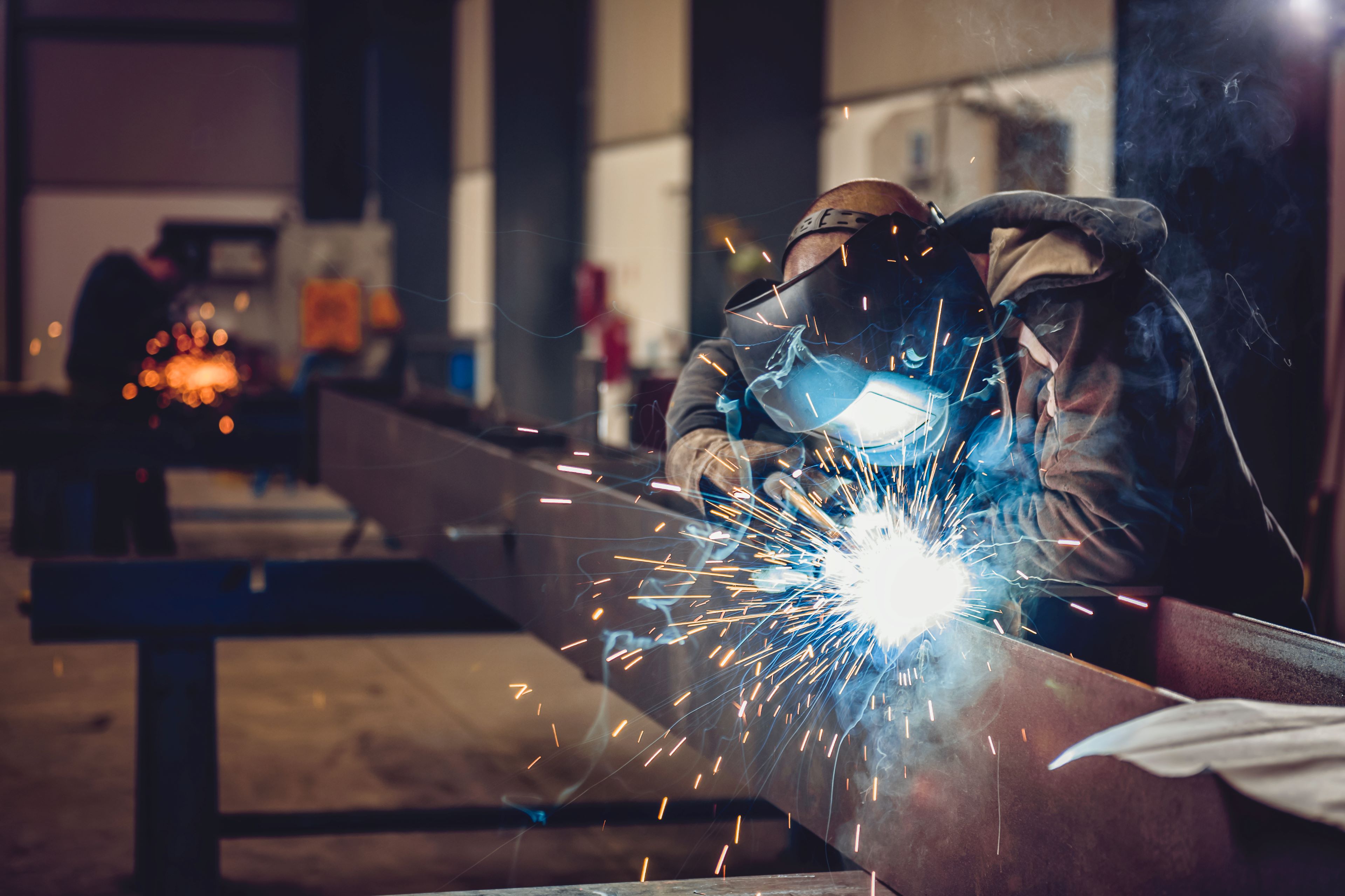 Men welding a steel object