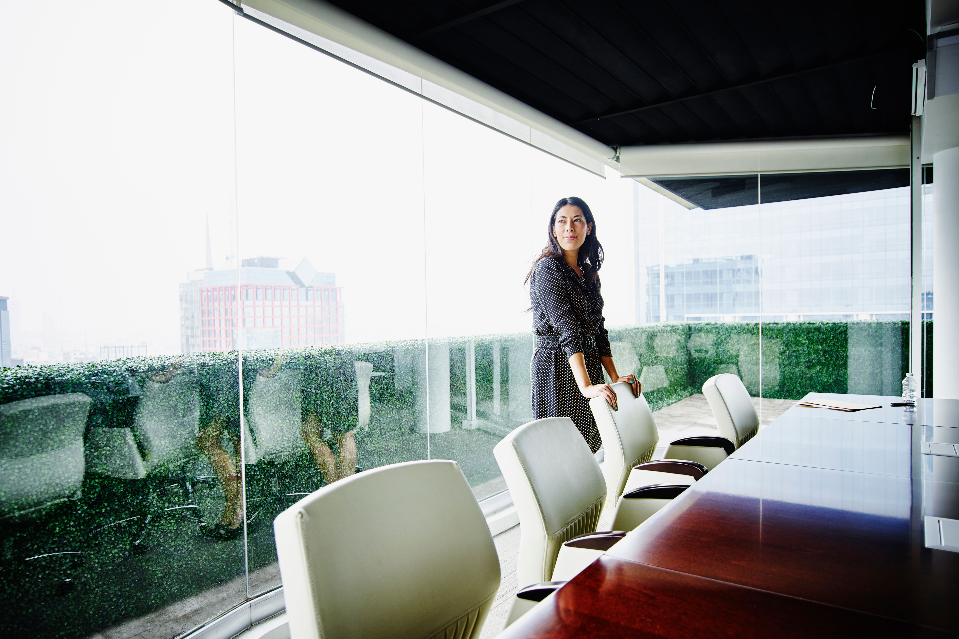 EY smiling businesswomen in office conference room