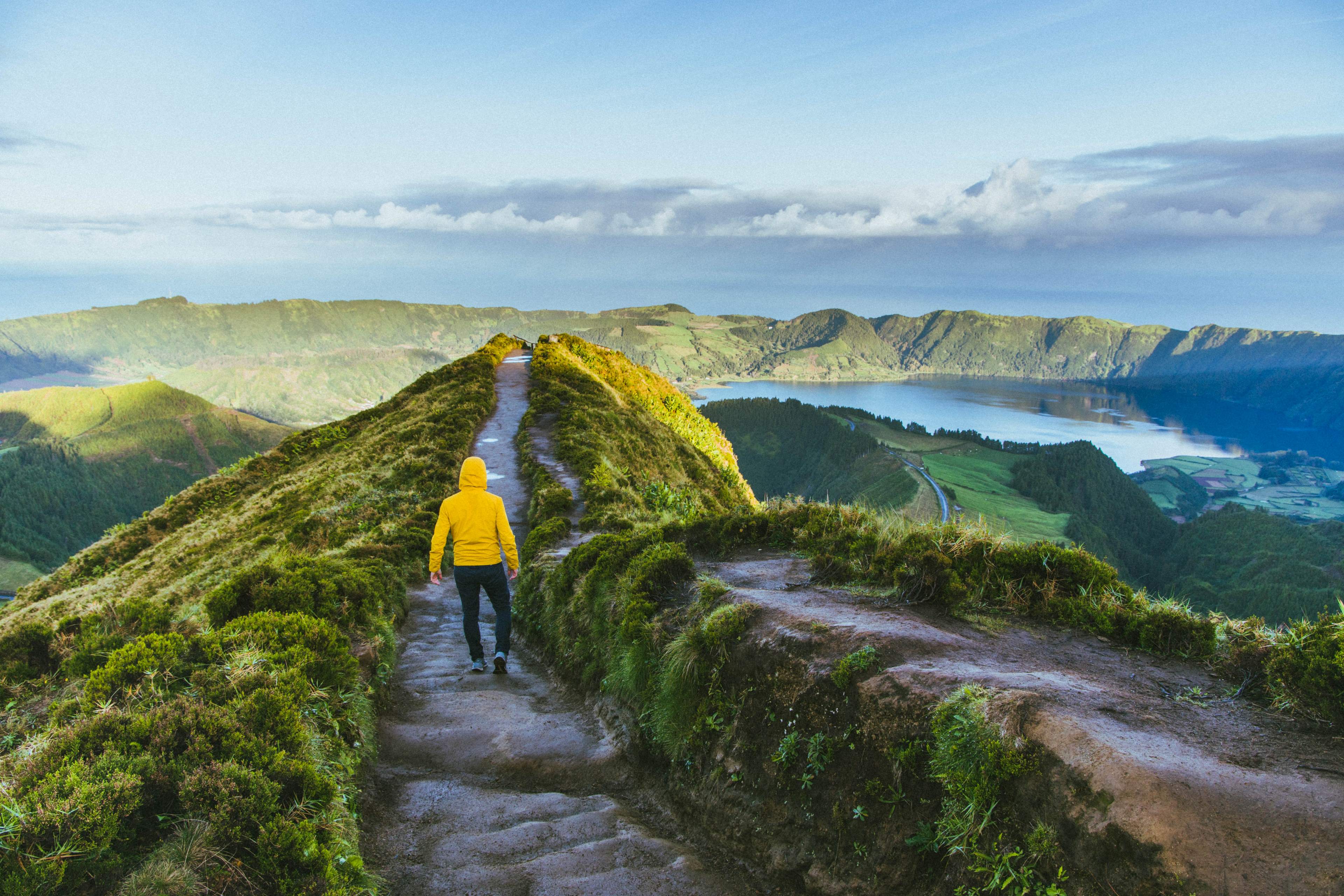 EY man walking on top of mountain