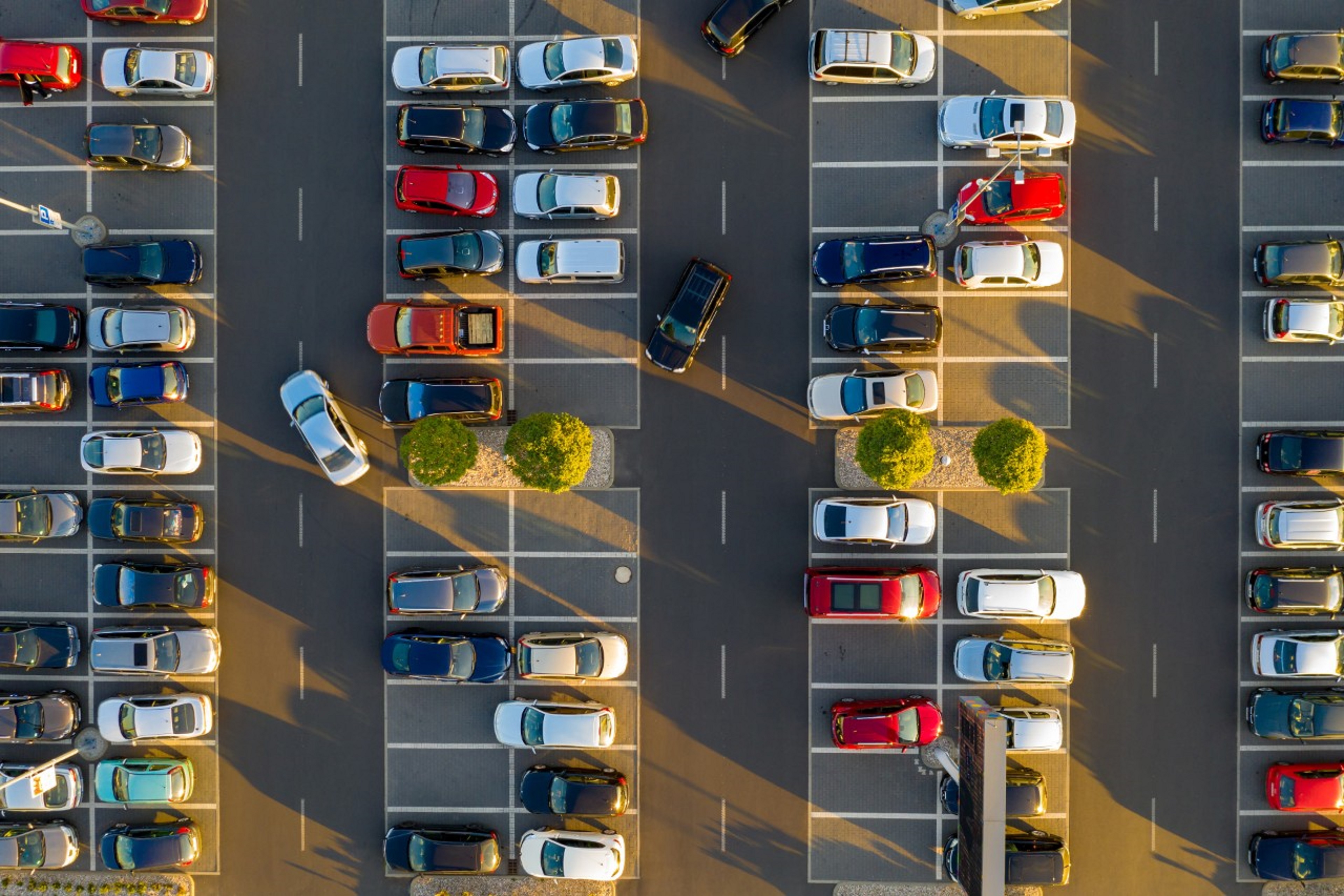 Aerial photo of a busy car park with car reversing into a parking space.