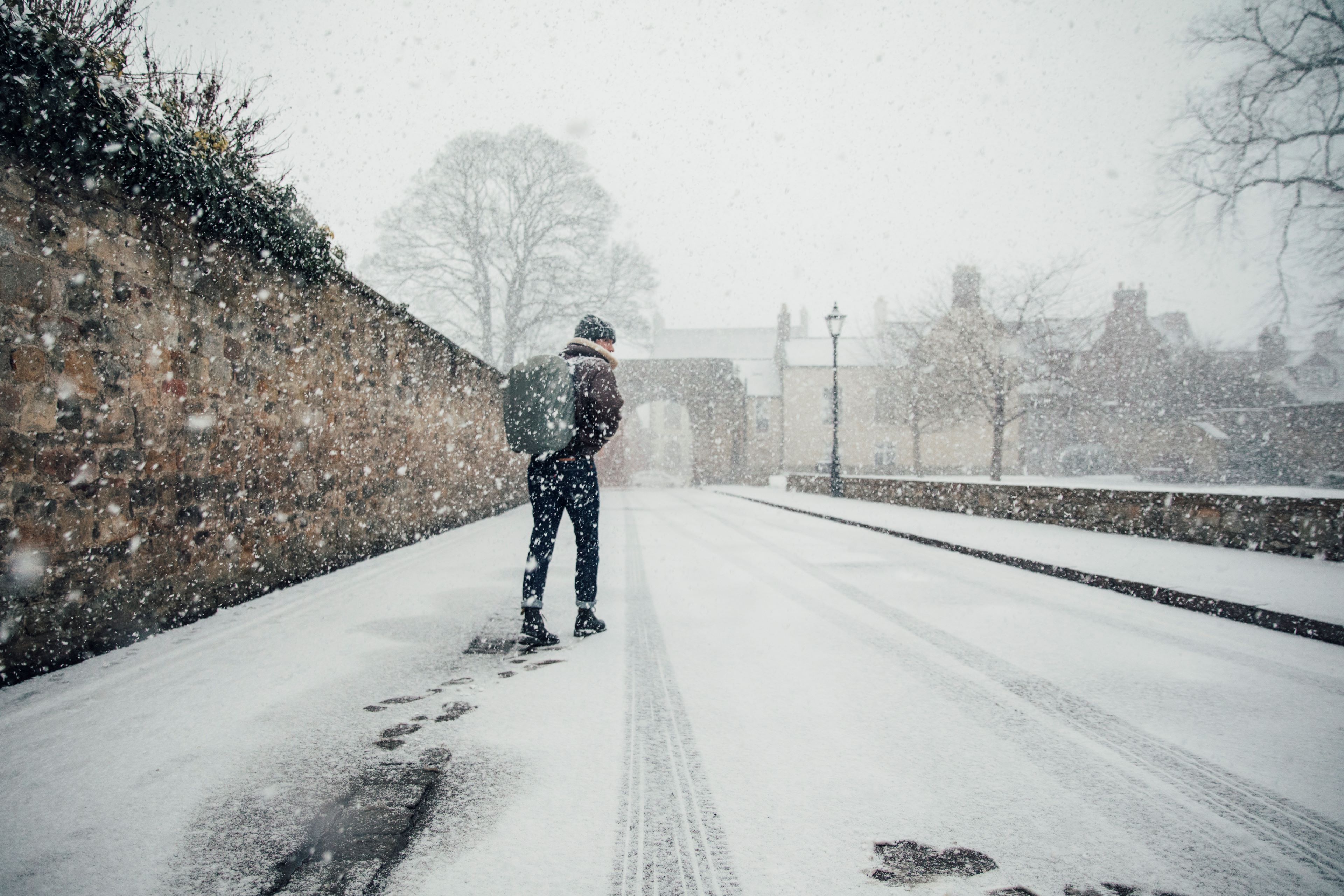 Man struggling to walk in snow