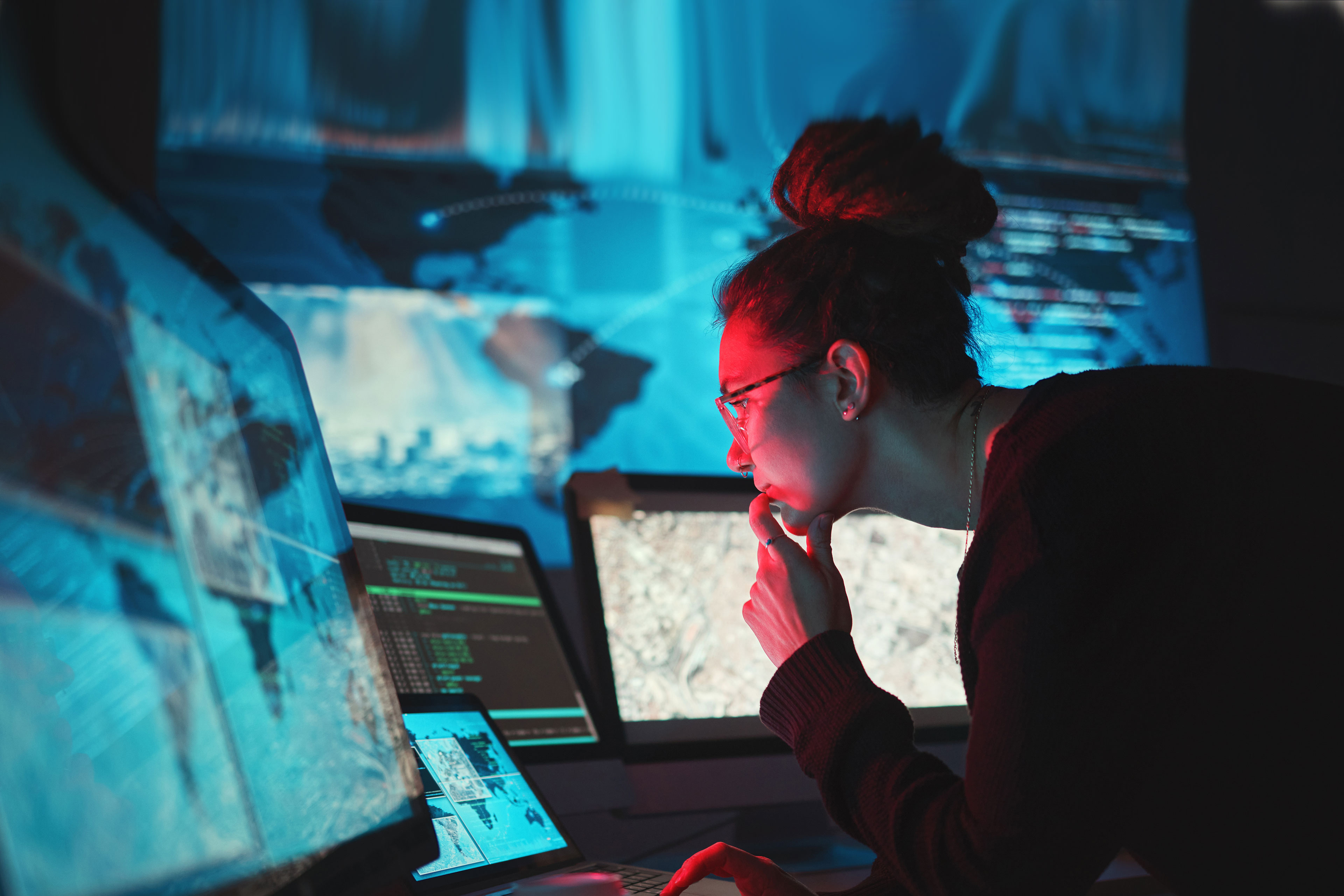 IT worker in dark room fixing hack