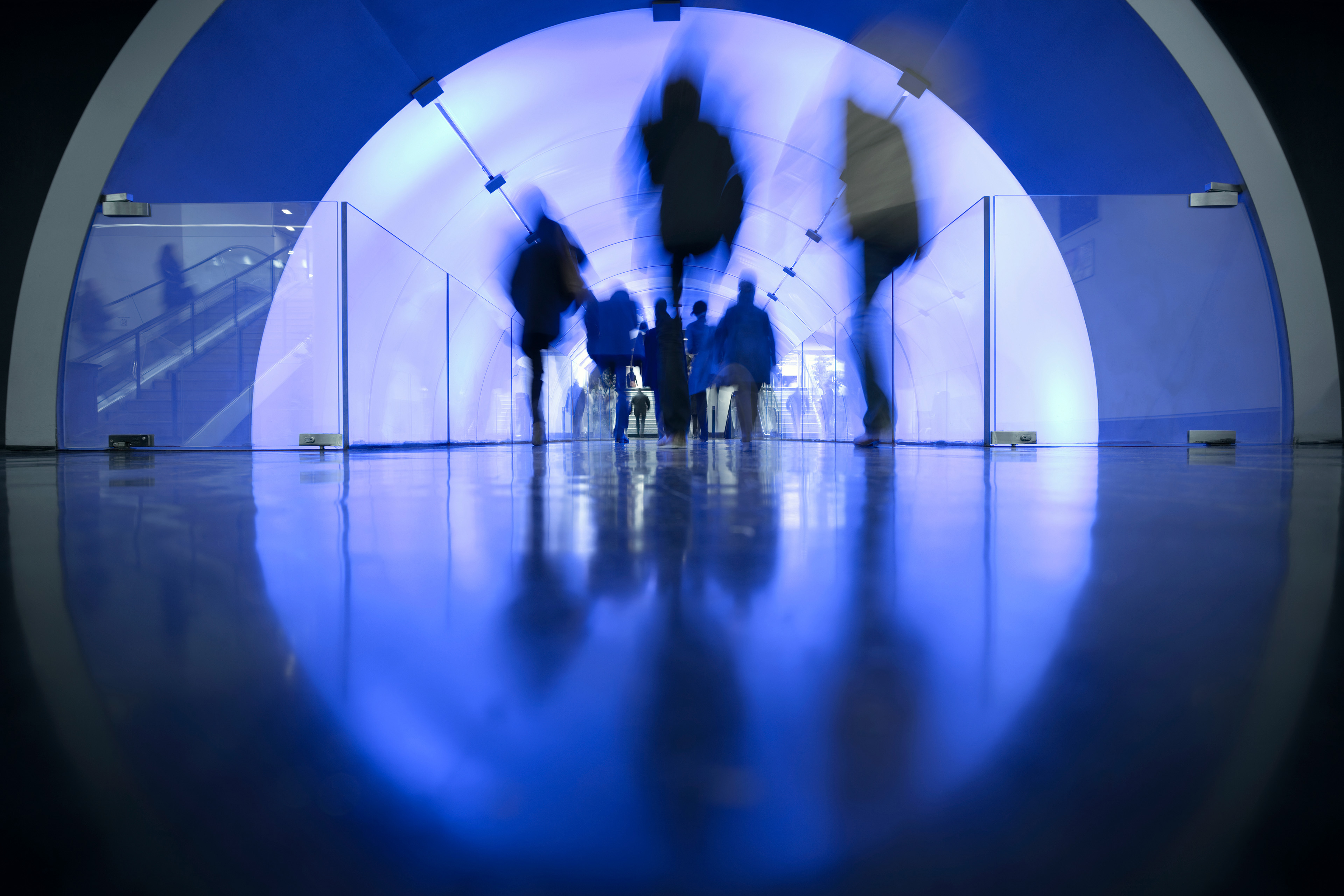 People passing led illuminated tunnel