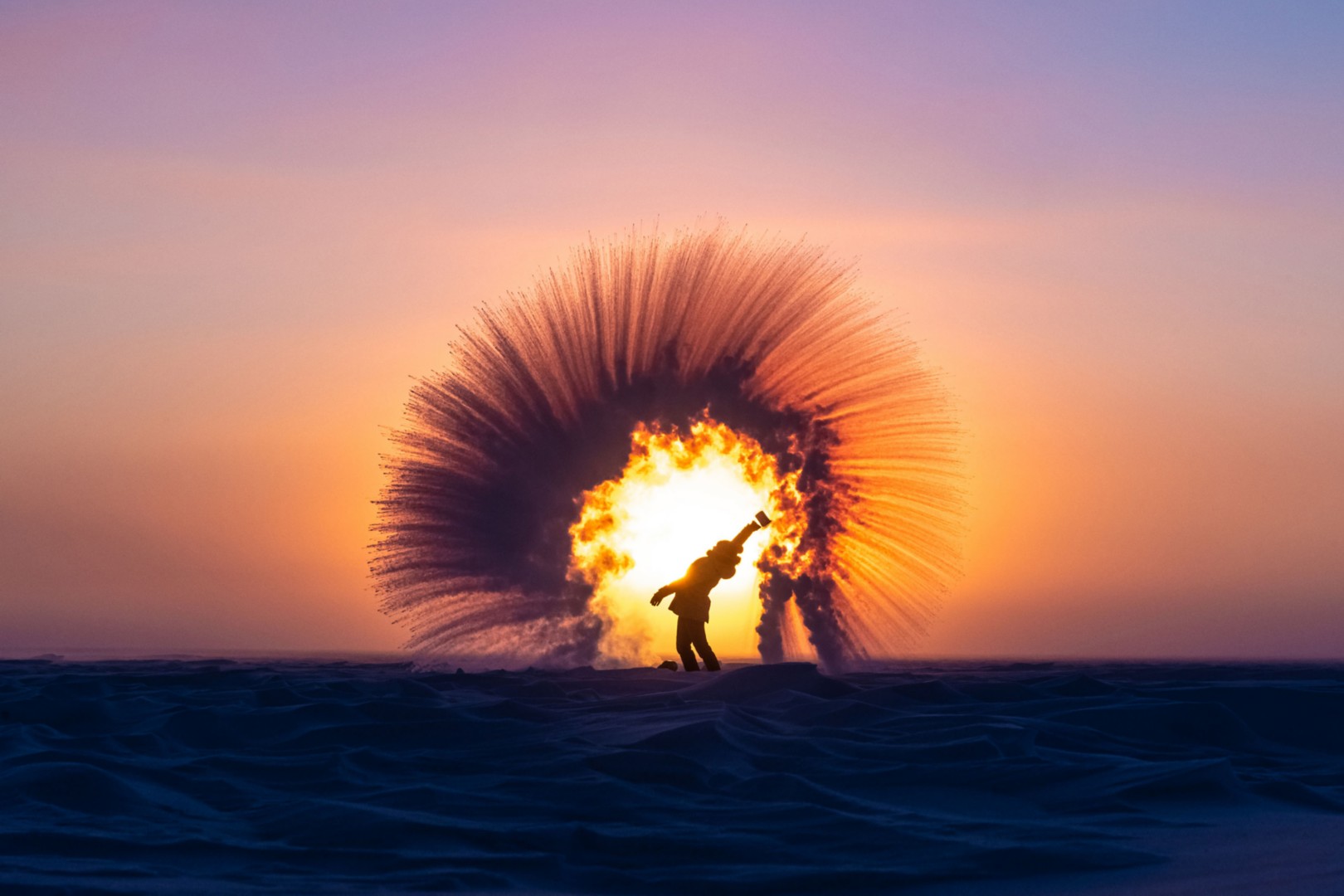 Woman on a frozen lake at sunris