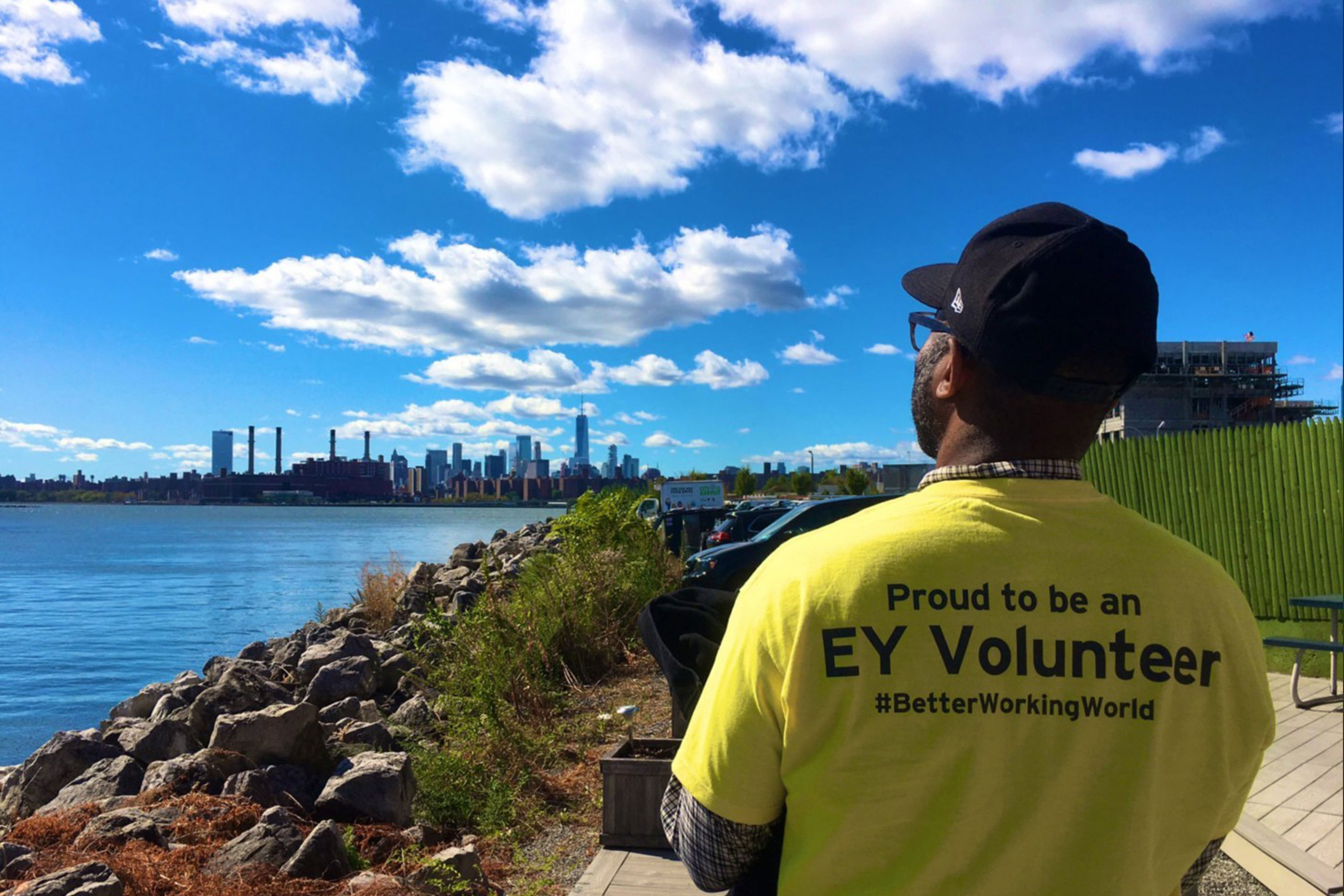 Man in "Proud to be an EY volunteer" T-shirt