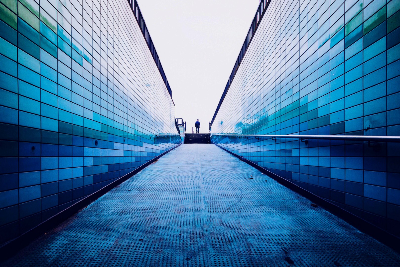 ey man walking footpath amidst surroundings wall