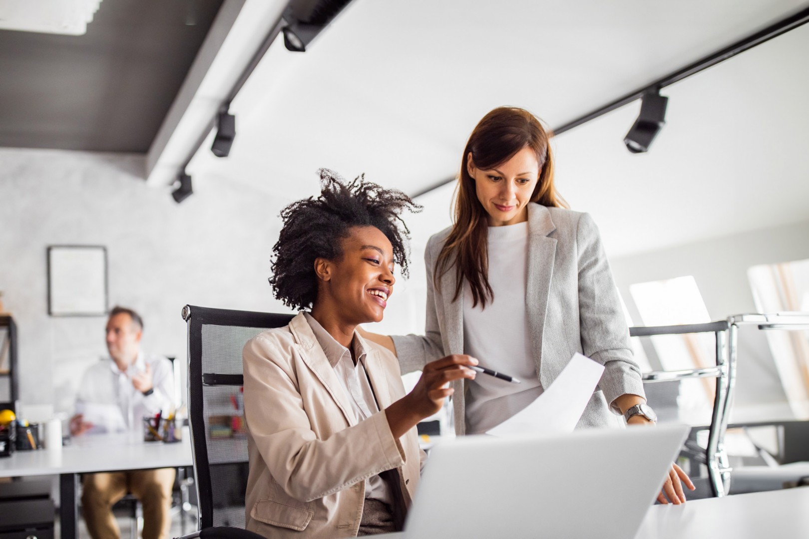 Woman showing something to another colleague