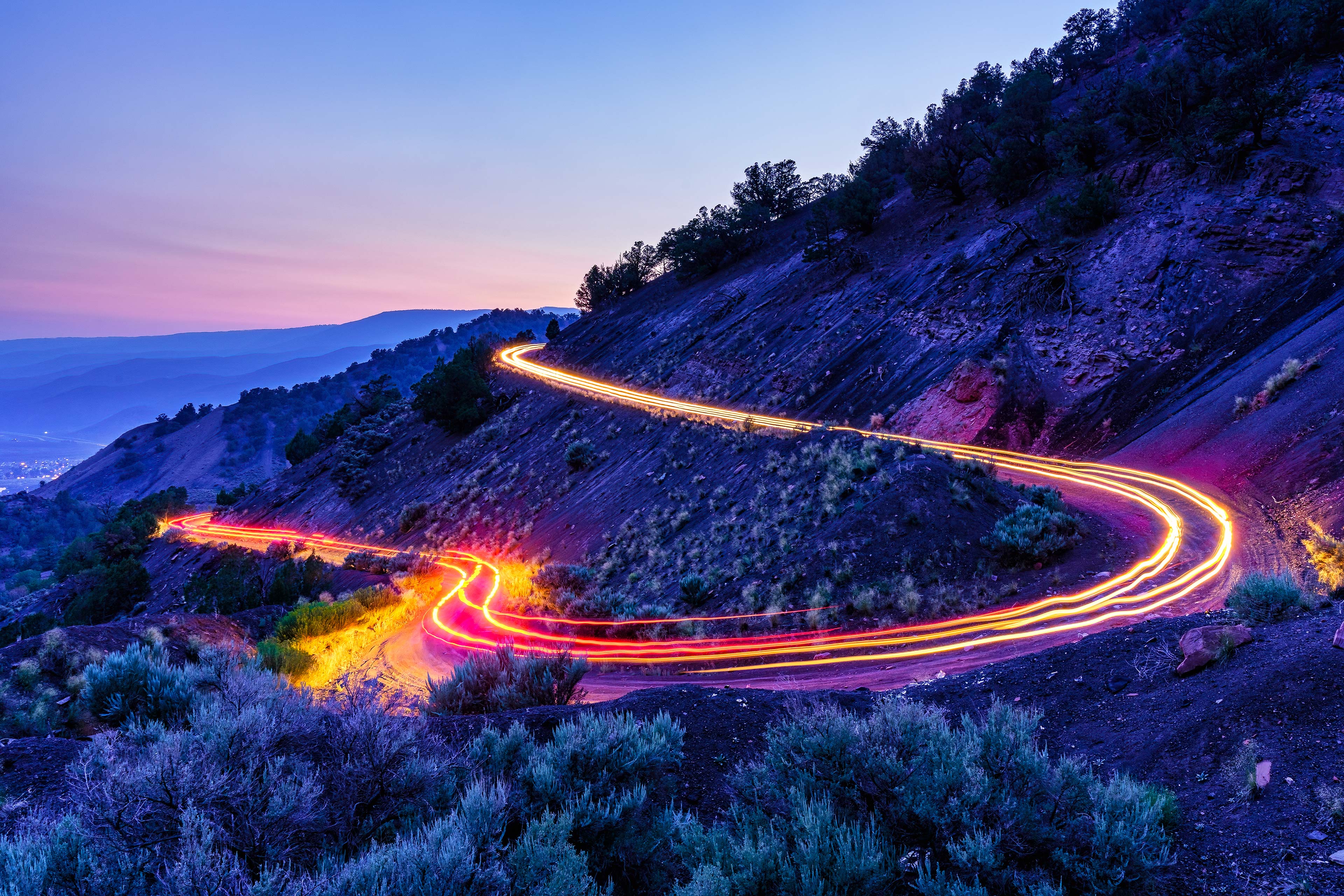 Long exposure light trails curvy mountain road