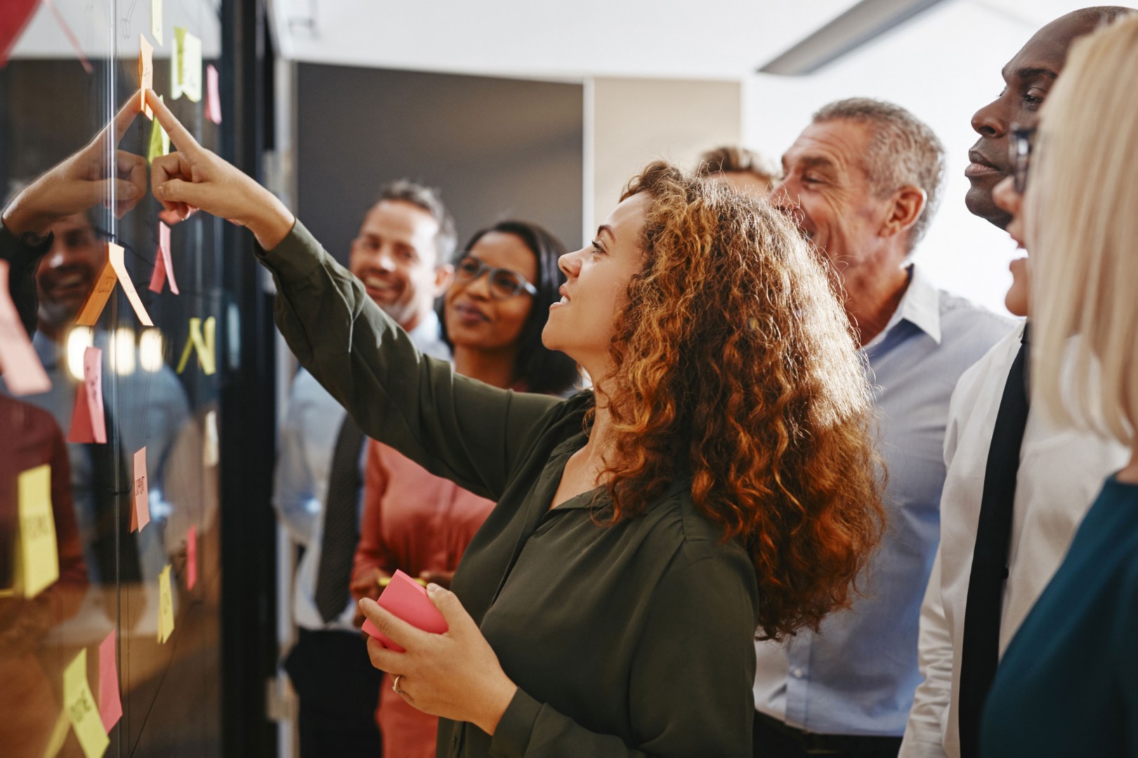 Businesspeople brainstorming with stickynote board